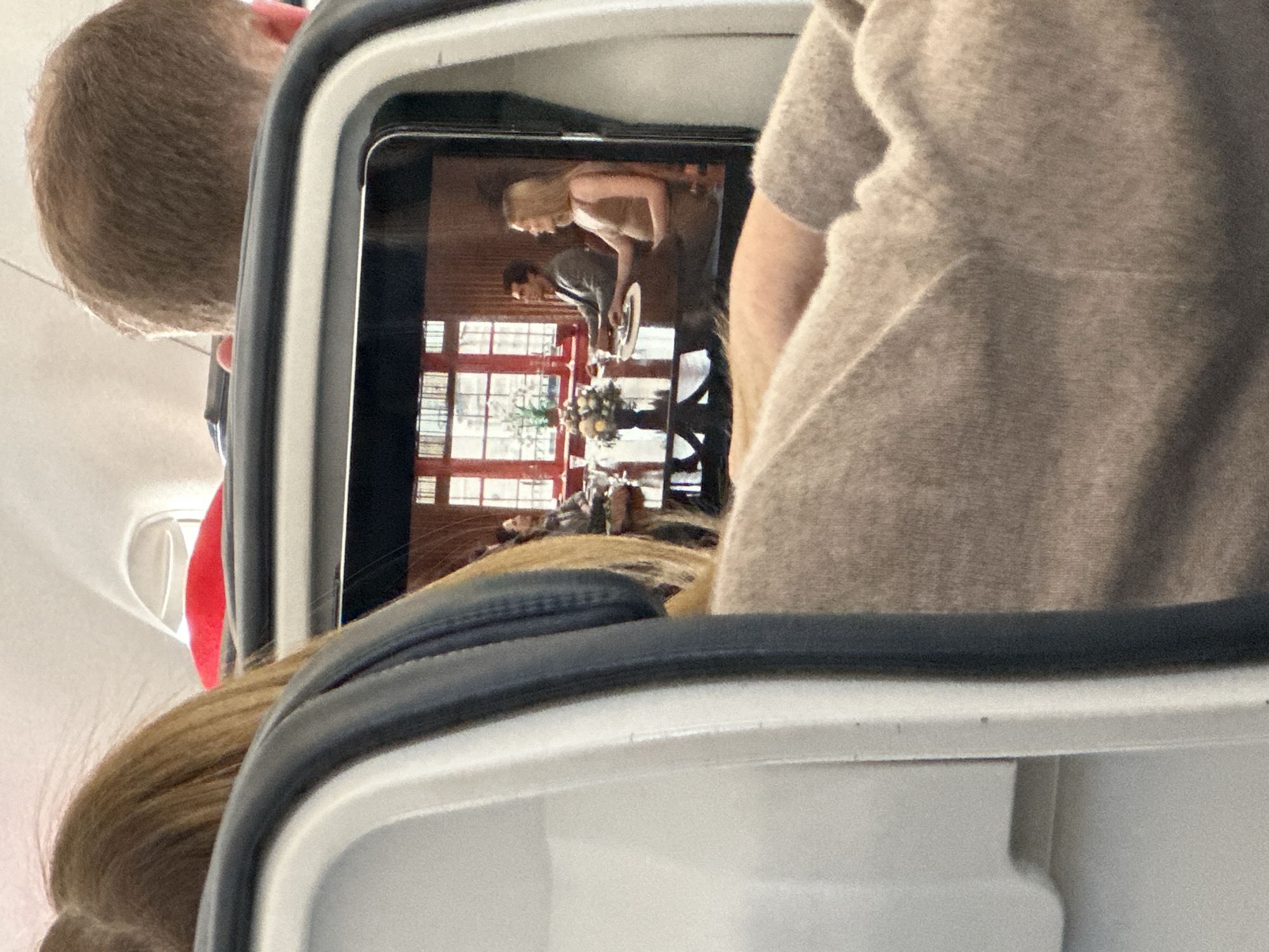 Passenger watches video on device during flight over Ibiza