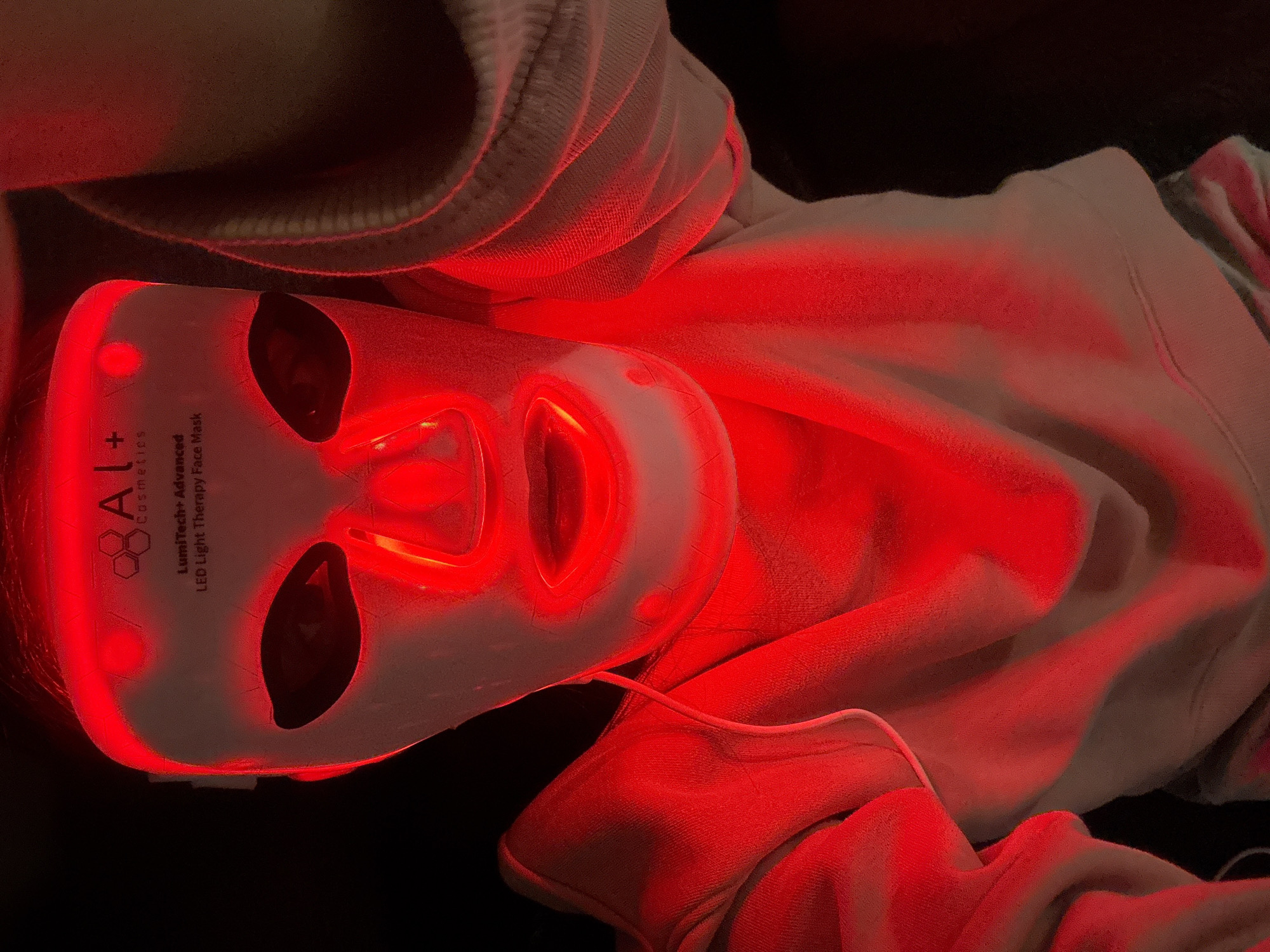 Person spotted wearing glowing red LED therapy face mask