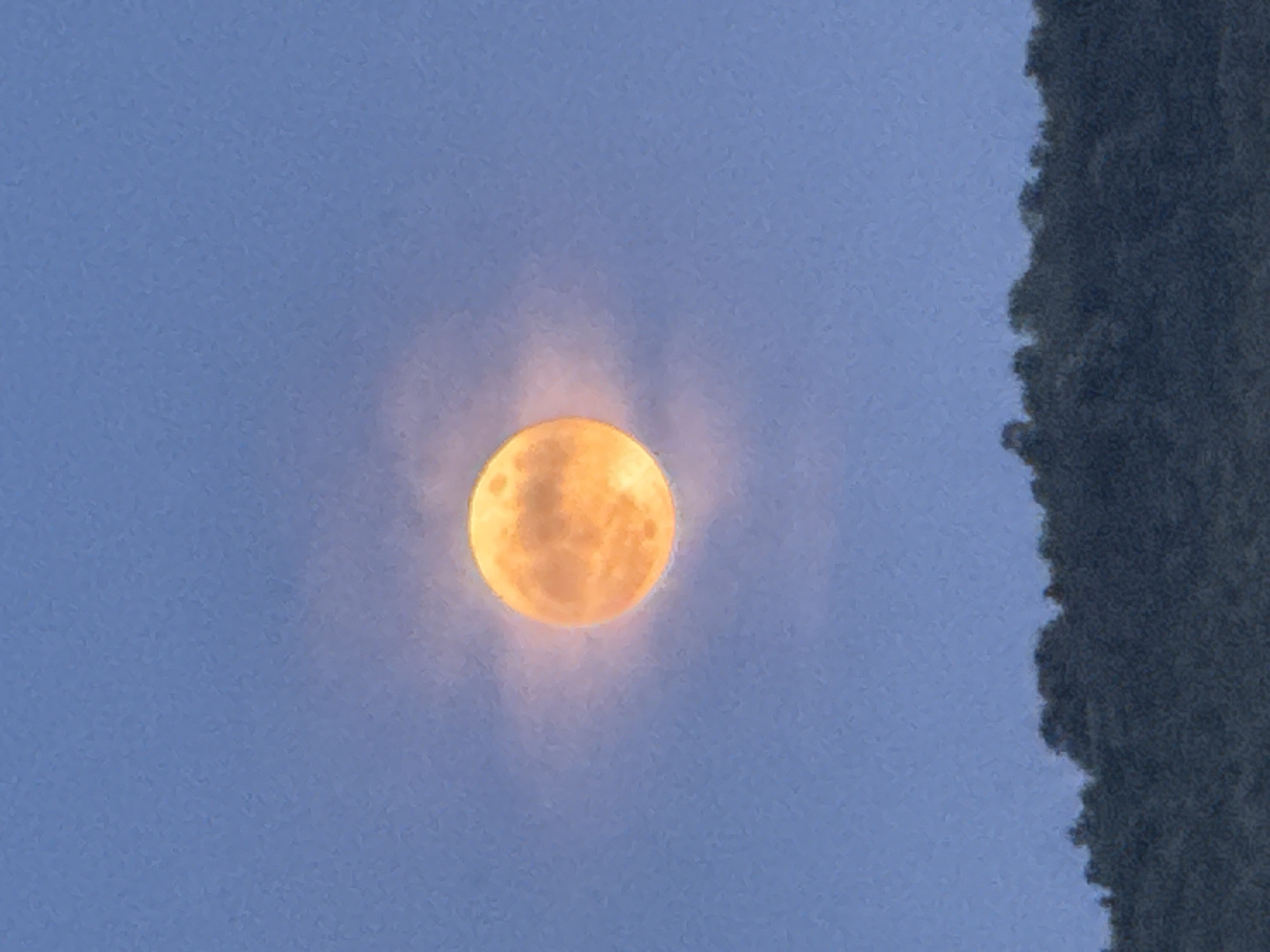Full moon observed through clouds in Strazhitsa, Bulgaria