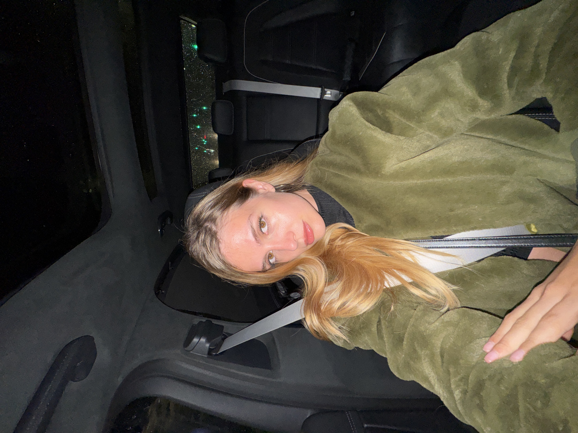 Woman photographed in car backseat in Tbilisi at night