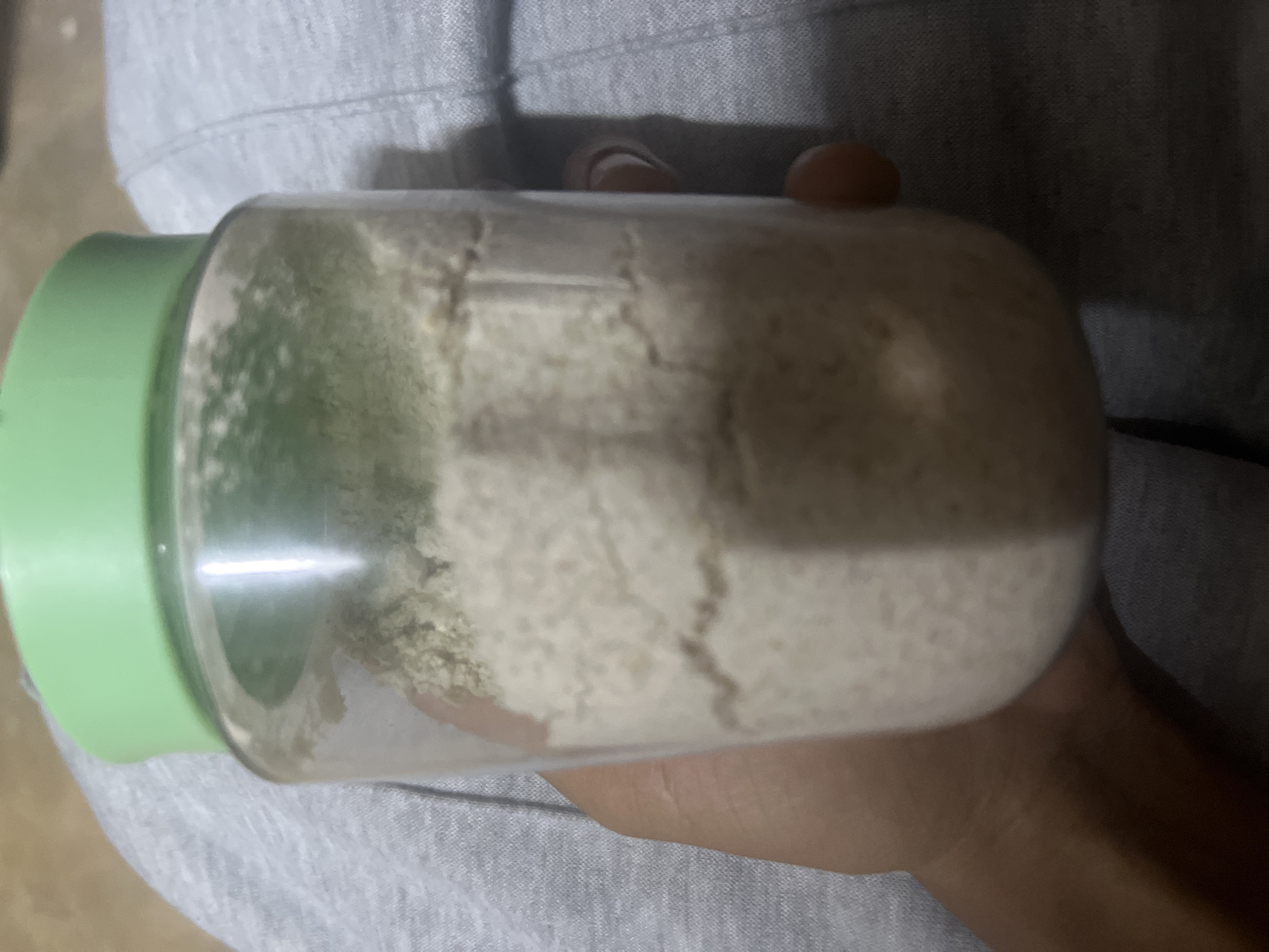 Person holds powder-filled jar in Dar es Salaam
