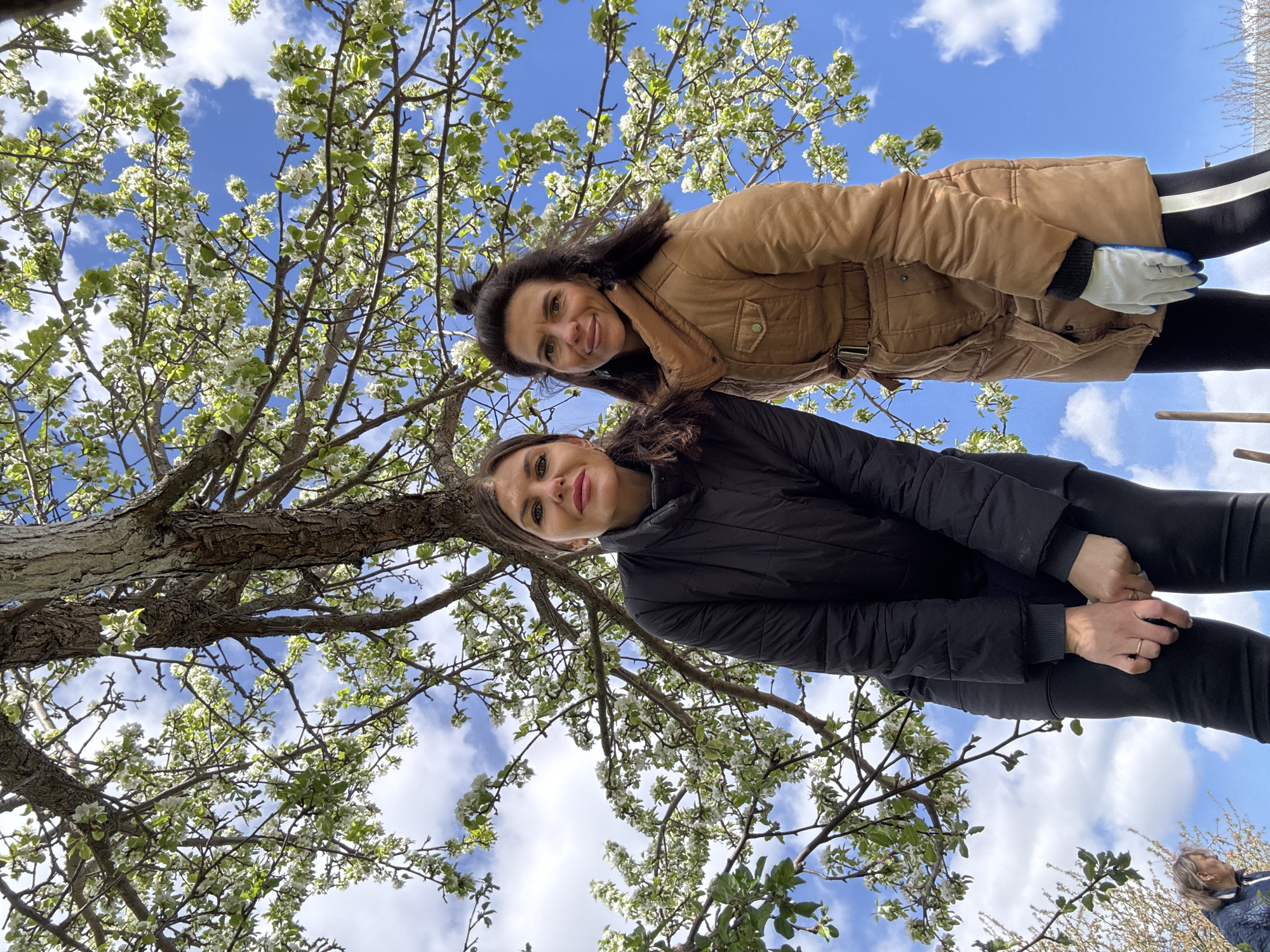 Women gather under blossoming tree in Dubovaya, Russia