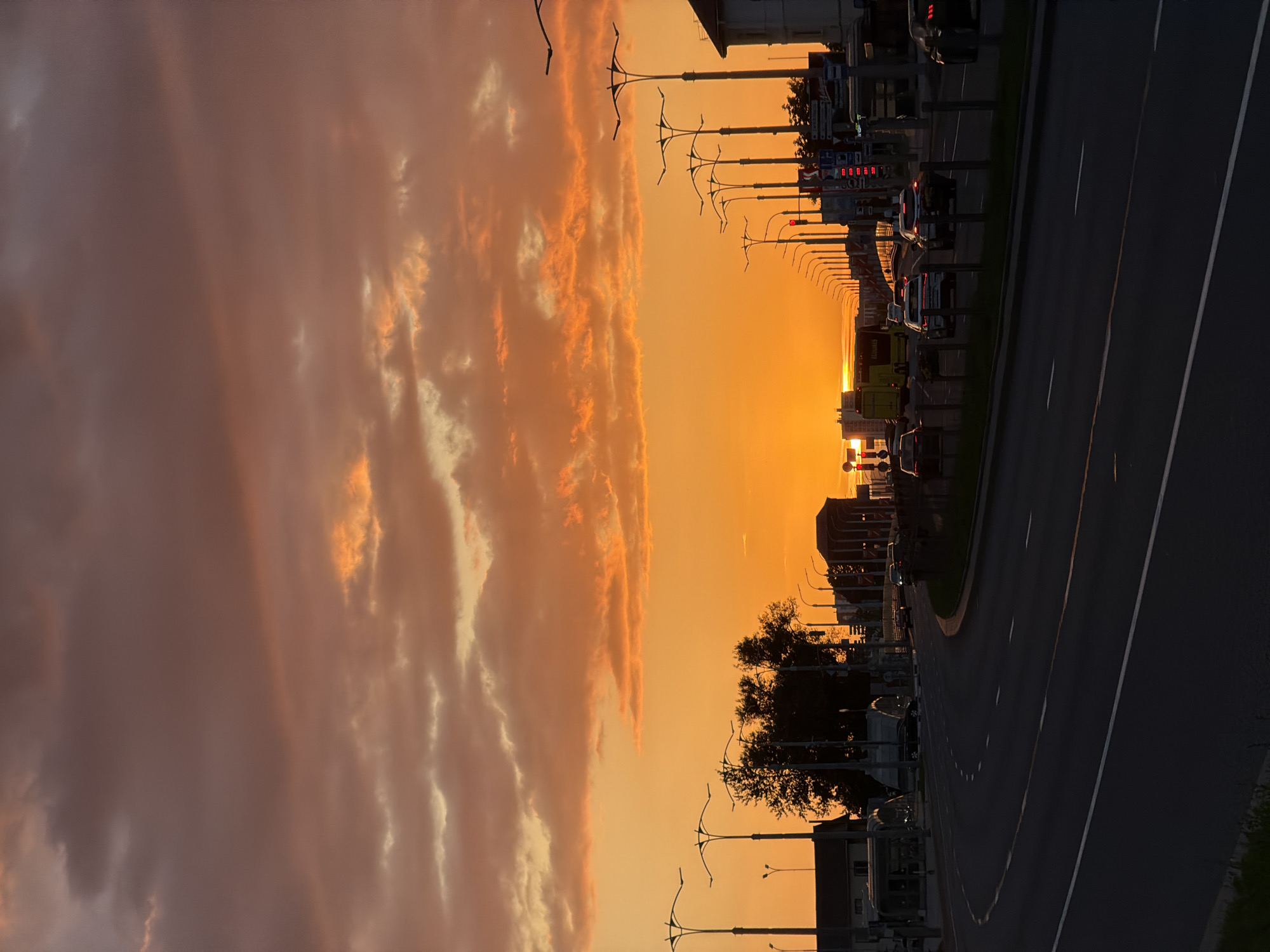 Orange sunset sky over Minsk city streets
