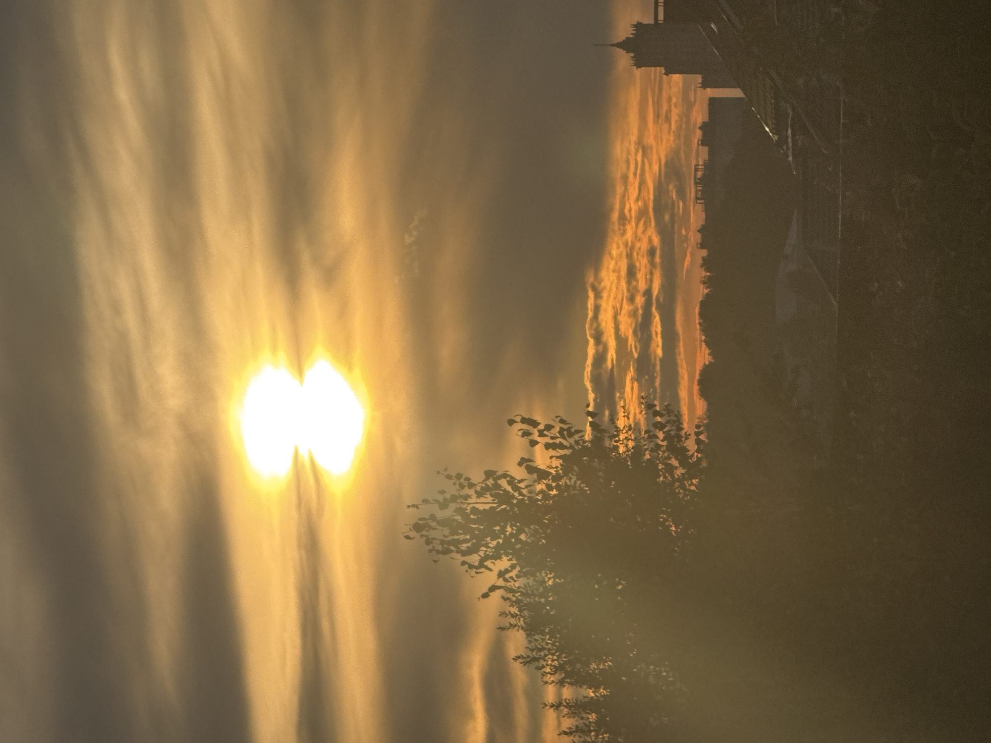 Bright sunset breaks through wispy clouds over Zonalnaya Stantsiya