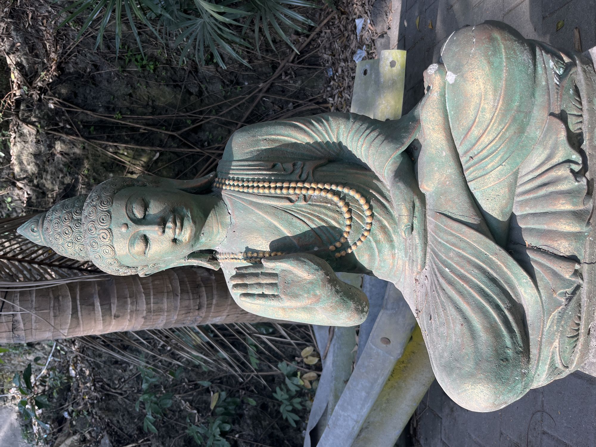 Weathered Buddhist sculptures documented at overgrown Kuta Selatan site