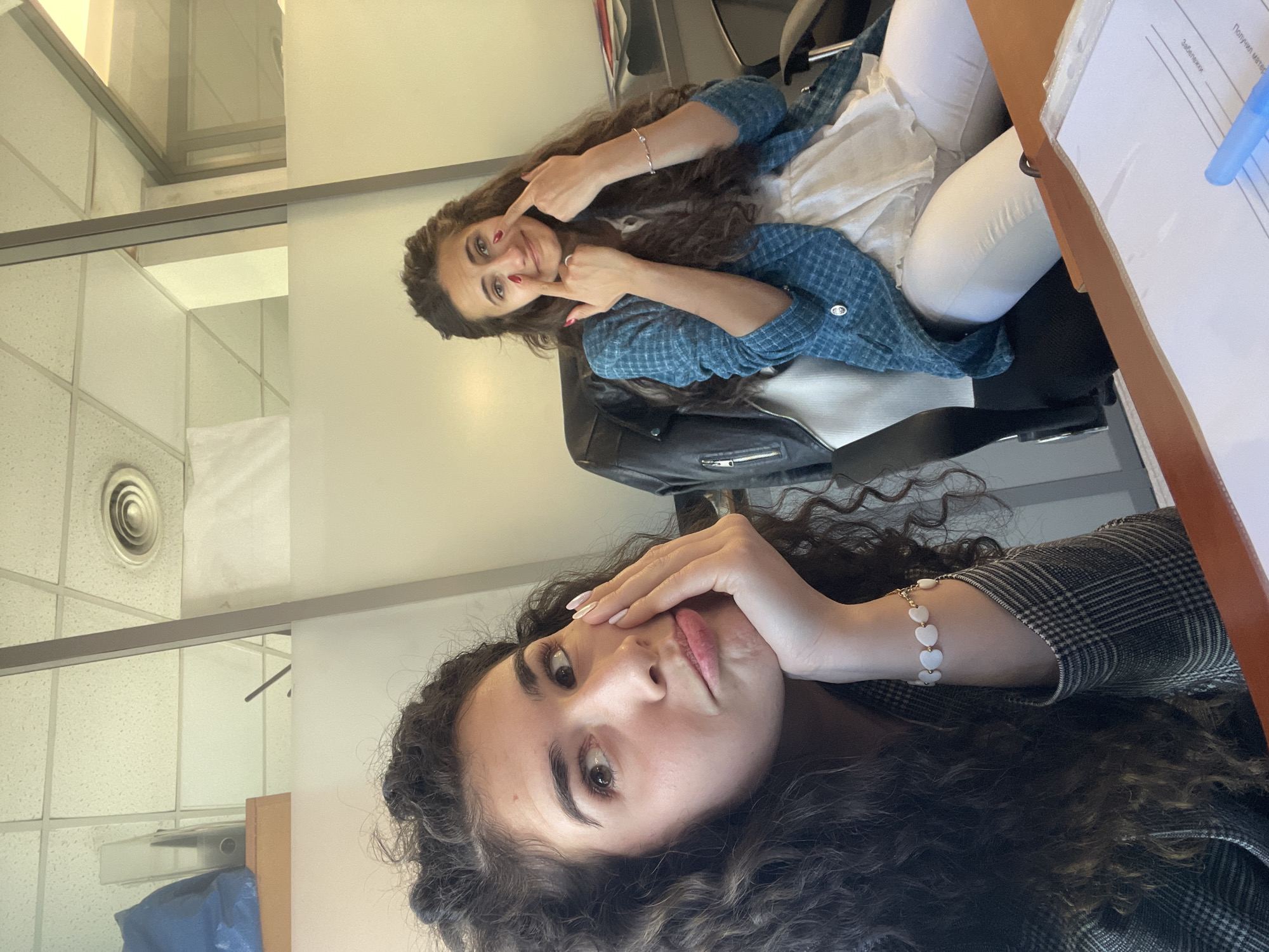 Two women share office break with selfies, snacks in Sofia