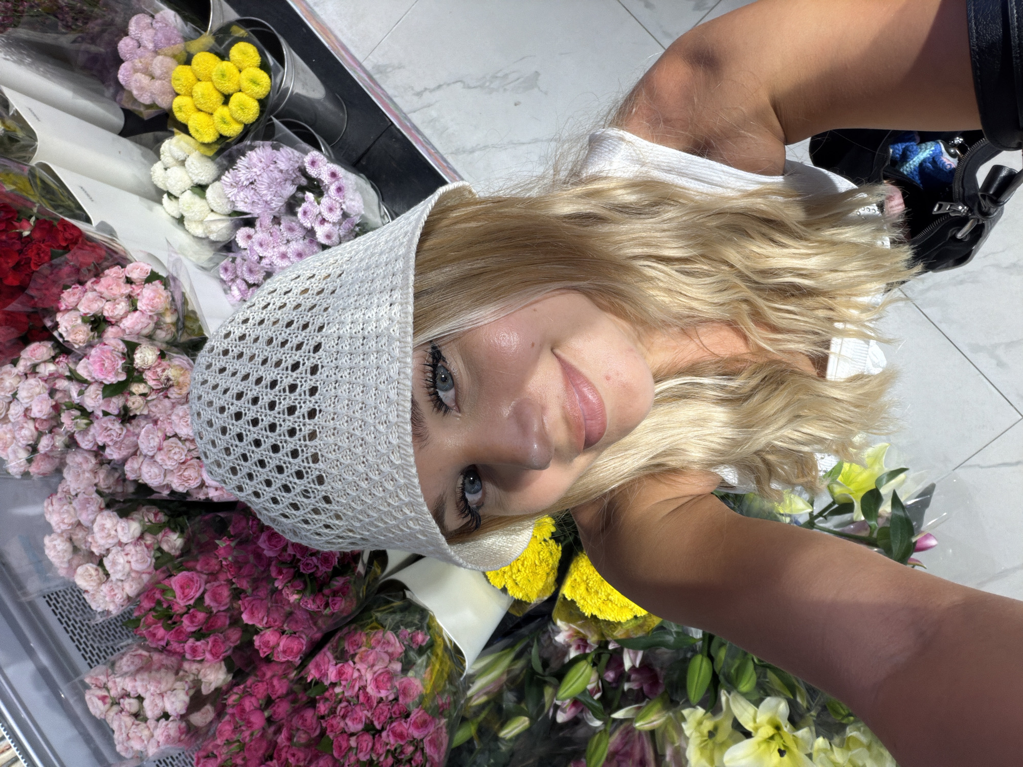 Browsing fresh flower bouquets at a Choeng Thale grocery store