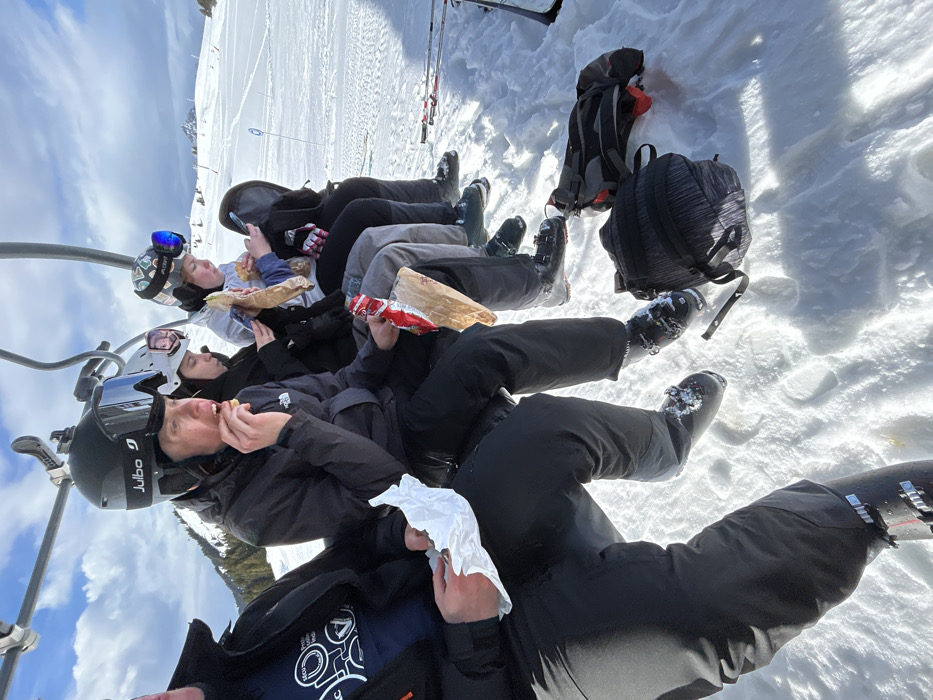 Five skiers ride chairlift in Villard-sur-Doron mountains