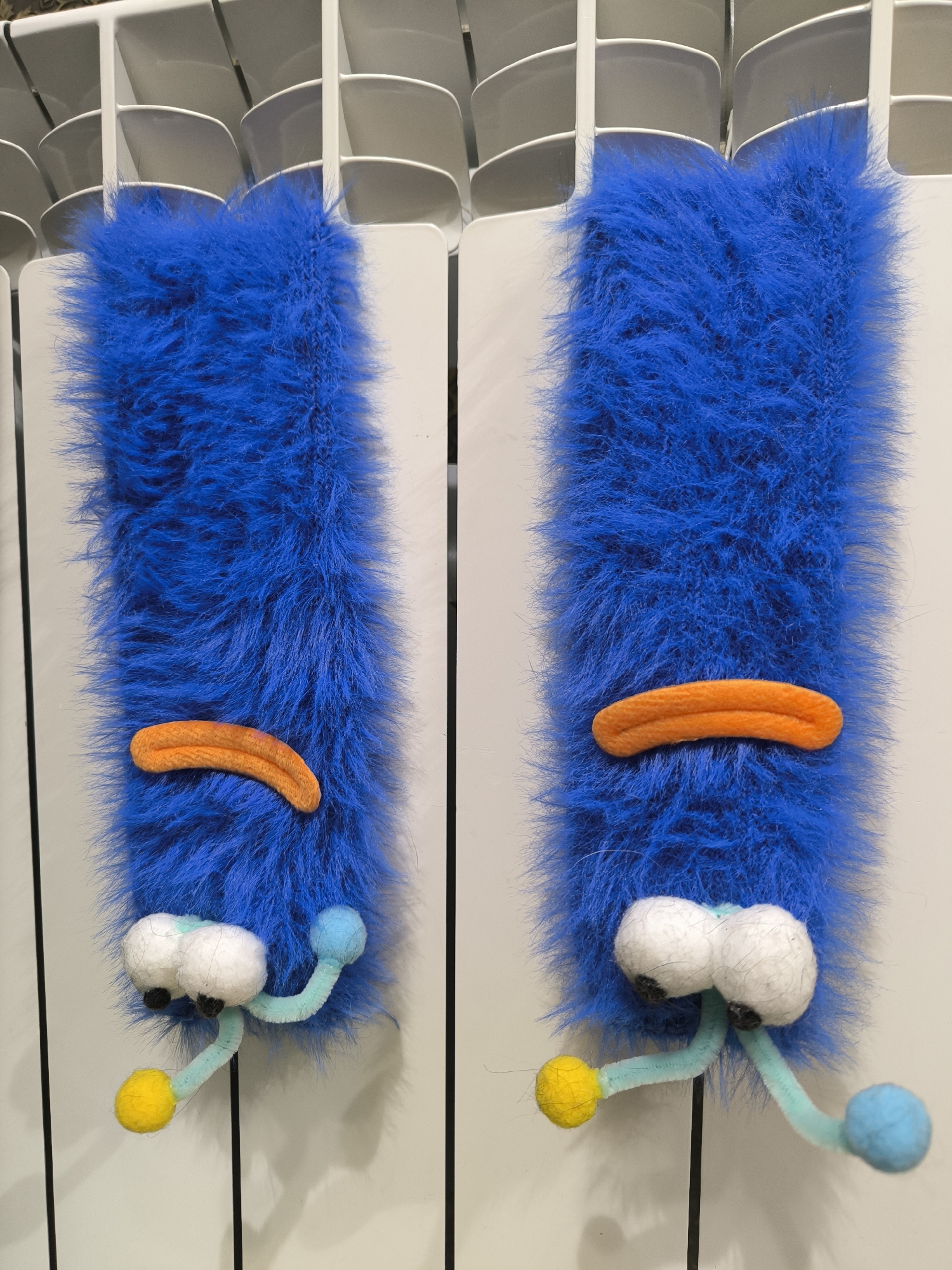 Blue furry decorations spotted on radiator in Russian home