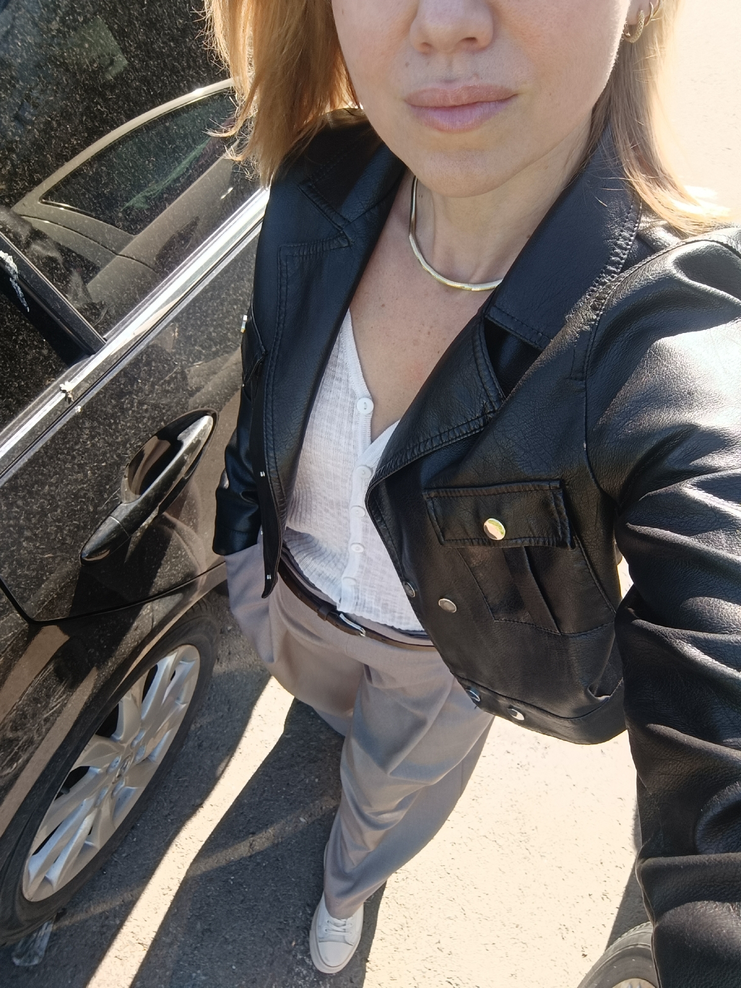 Woman in leather jacket spotted beside car in Naberezhnye Chelny