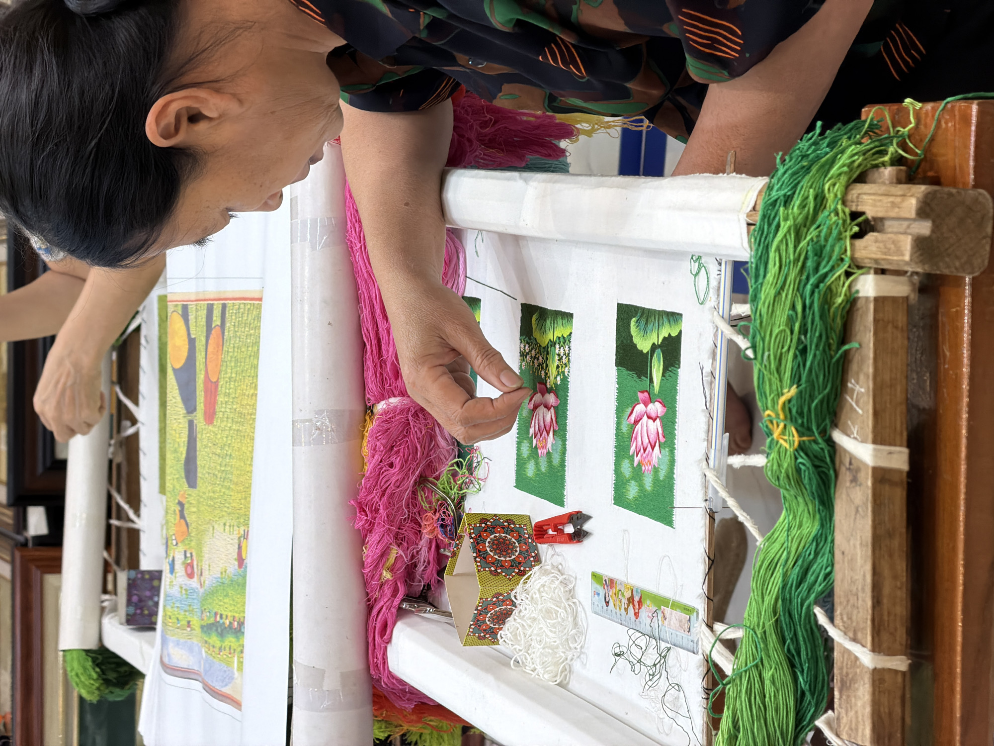Vietnamese artisan practices traditional embroidery in Hải Phòng workshop