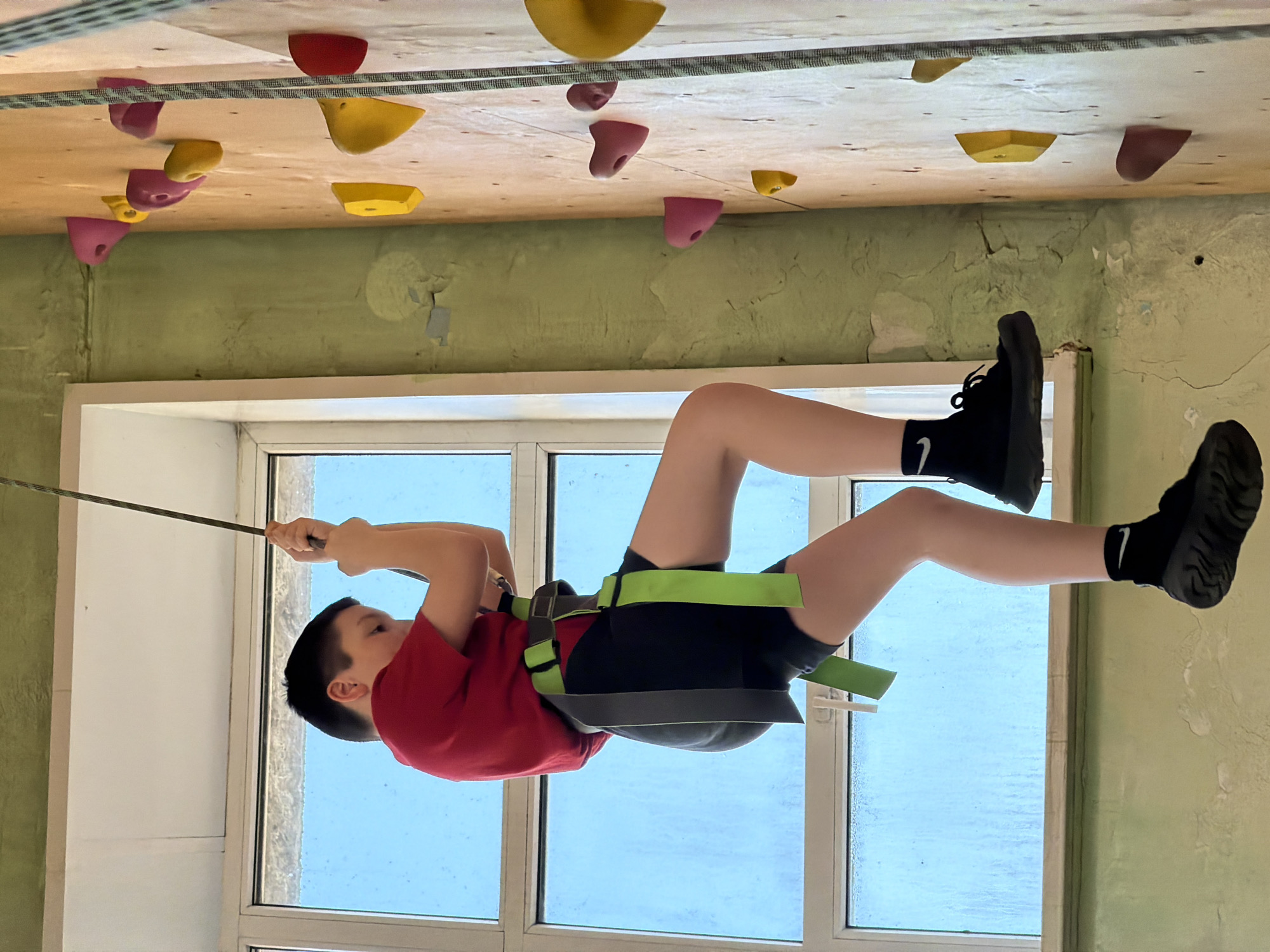 Young climber enjoys indoor rock climbing session in Izhevsk