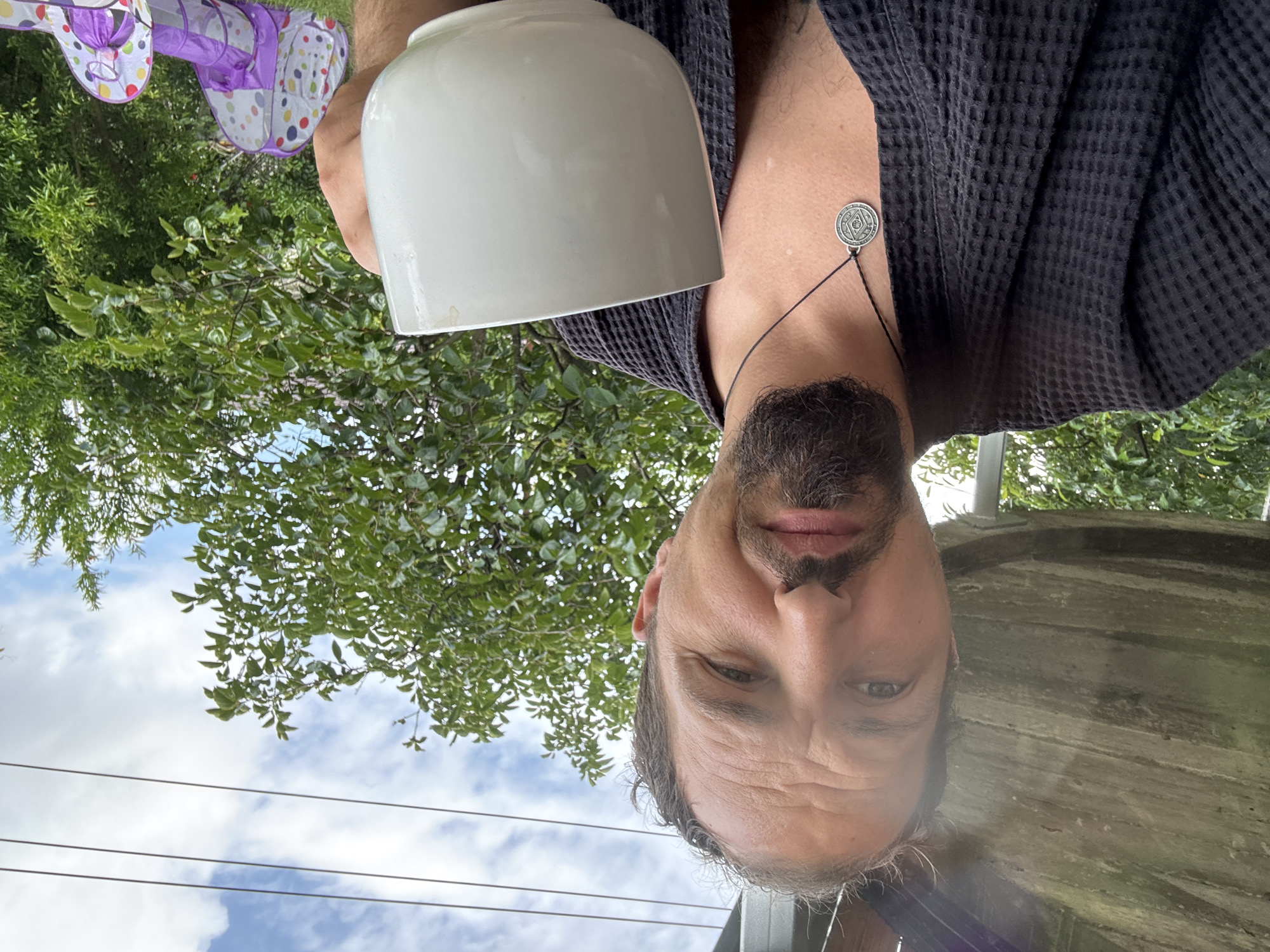 Lazy morning in a Sochi backyard — coffee, selfies, kids playing