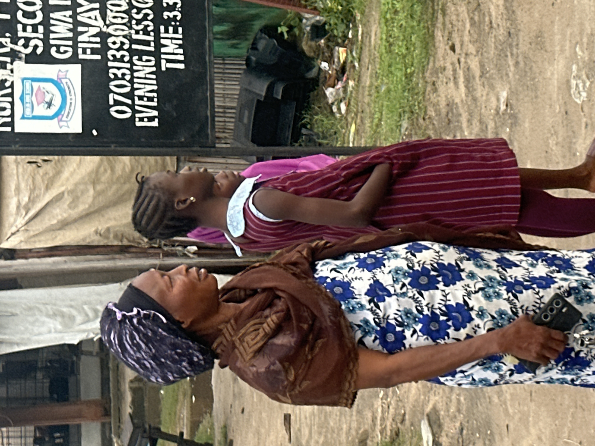 Morning street life along a Badagry sidewalk