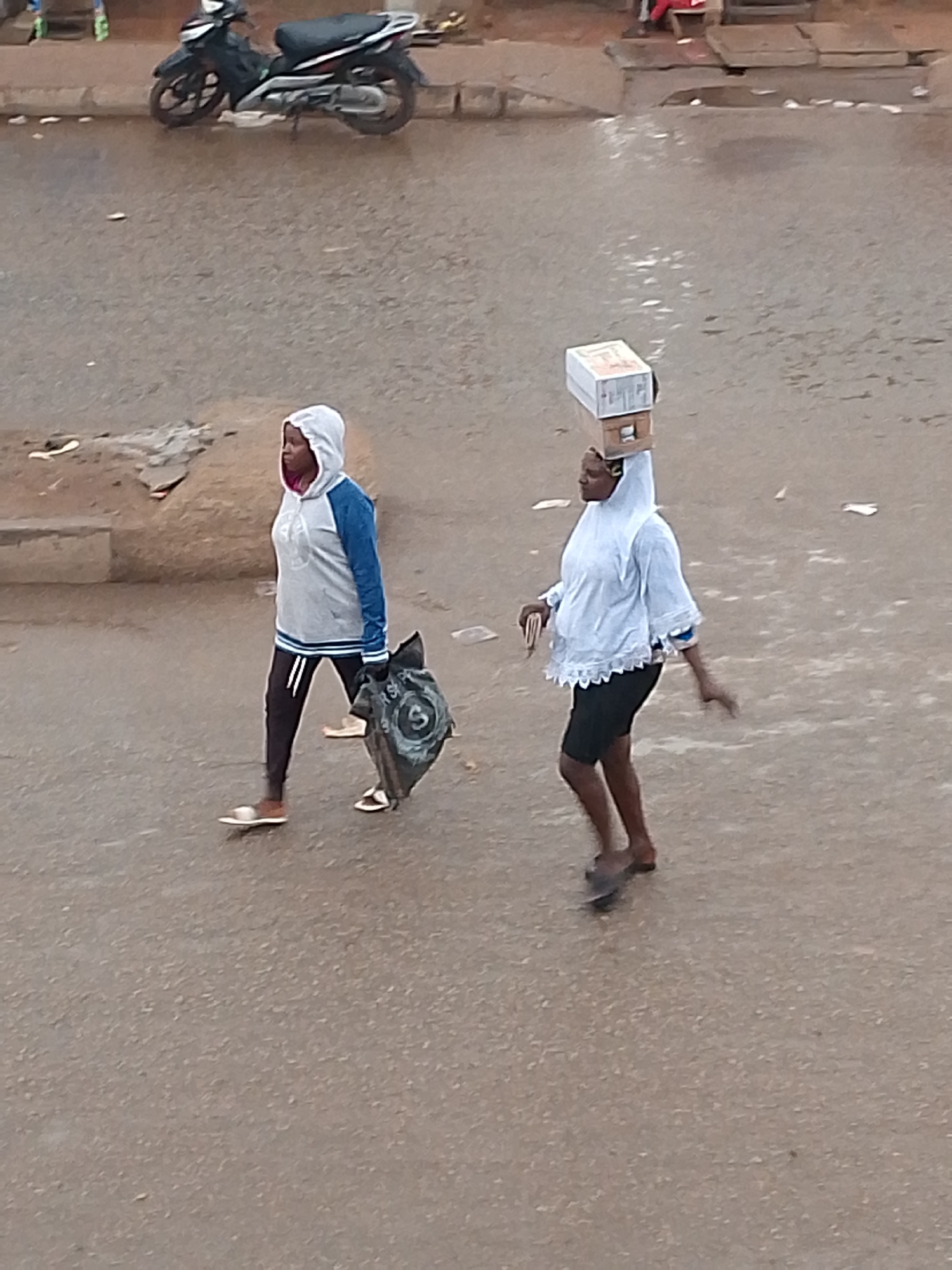 Rainy afternoon street life moving through Bukuru, Nigeria