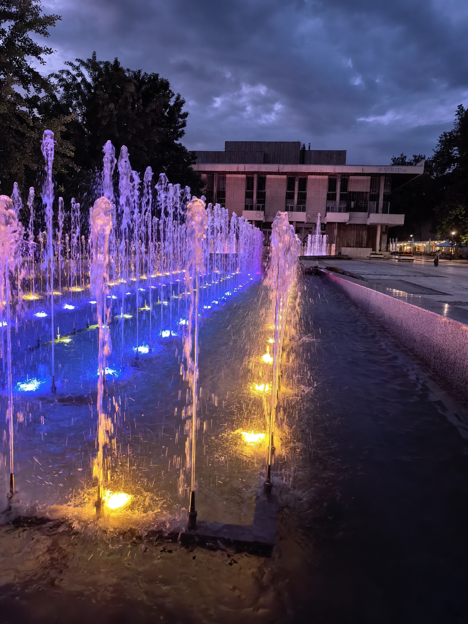 Illuminated fountain displays captured at dusk in Svishtov, Bulgaria