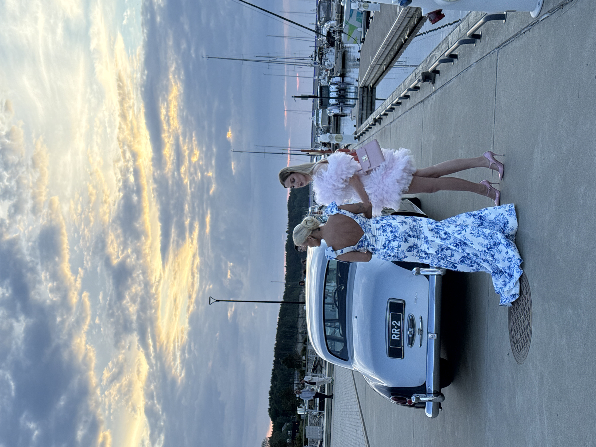 Luxury car gathering at Tallinn marina during golden hour