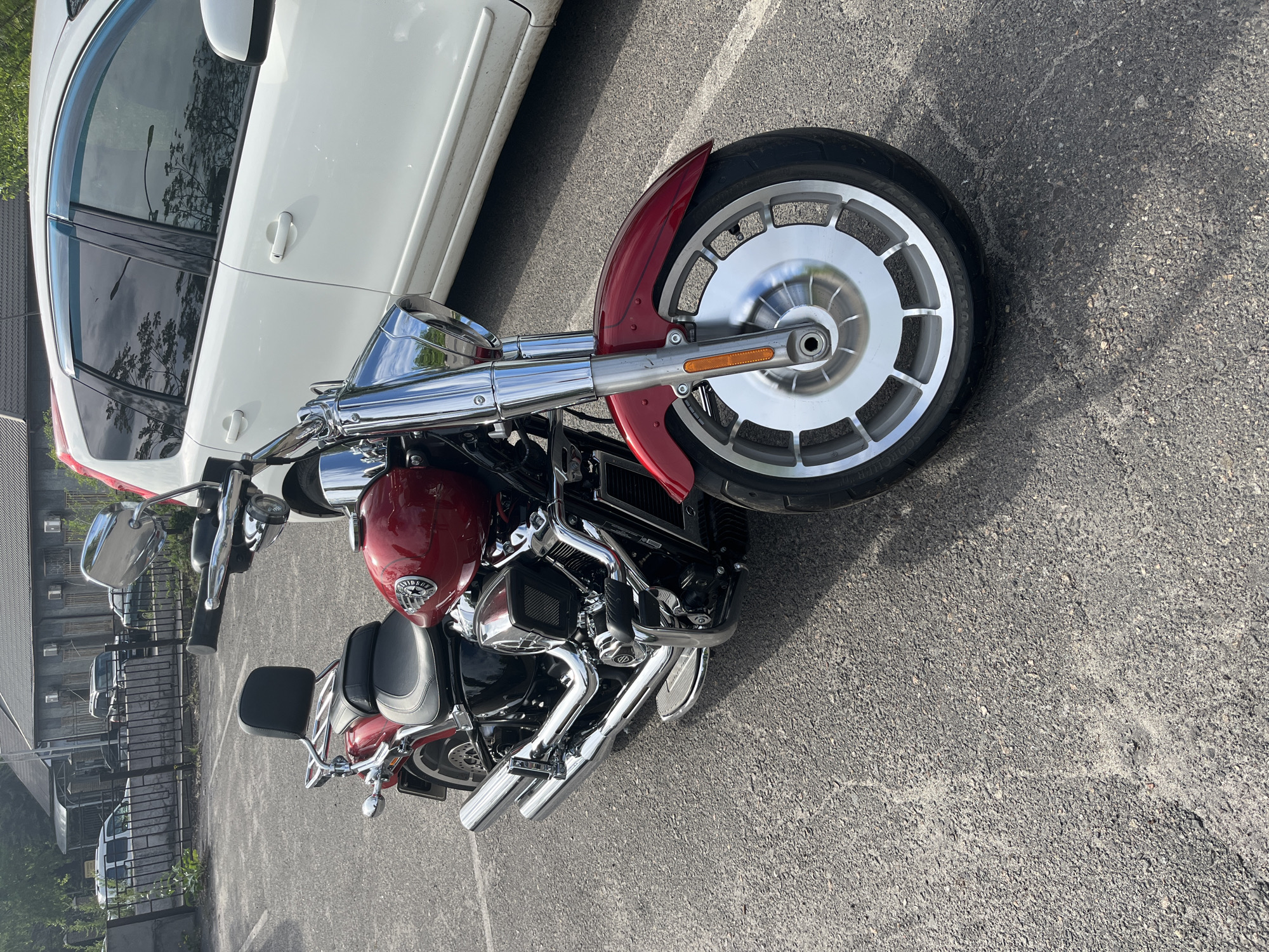 Red motorcycle parked among cars in Kryvyi Rih