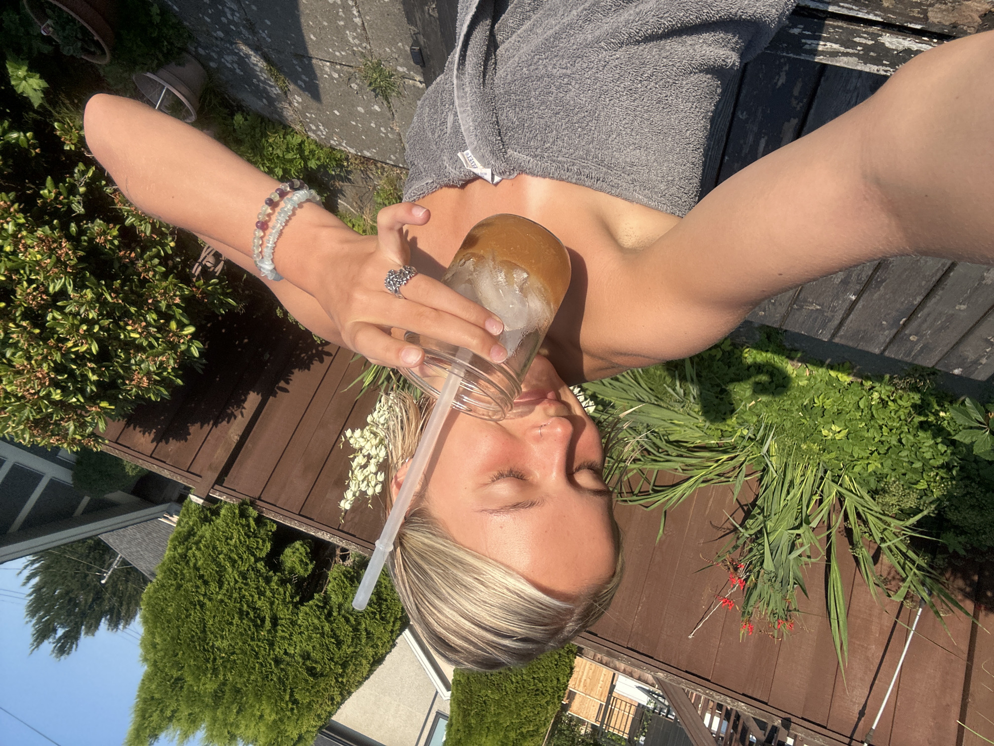 Iced drink in hand, surrounded by Vancouver greenery
