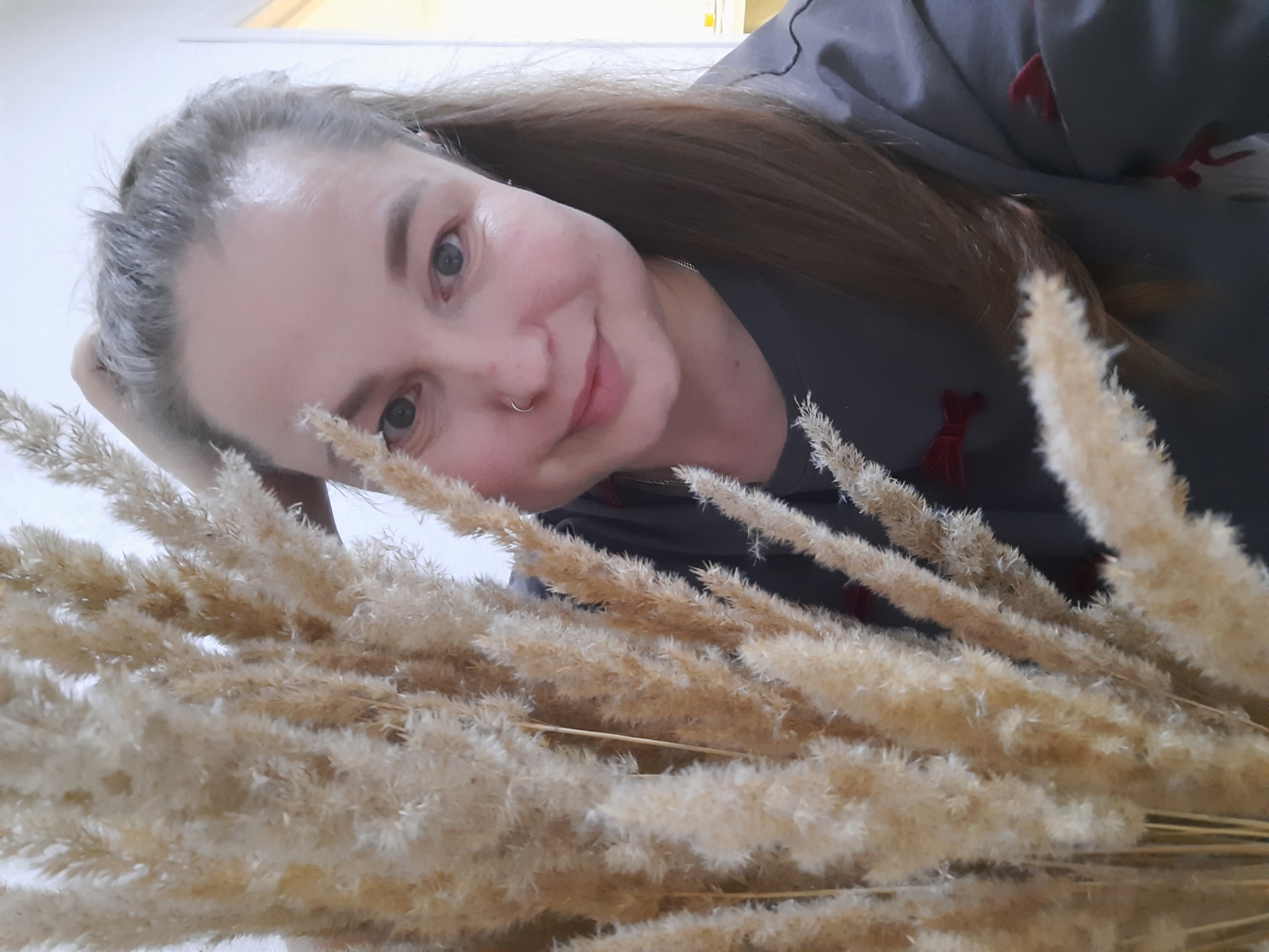 Woman photographed indoors with pampas grass in Pervomaysky