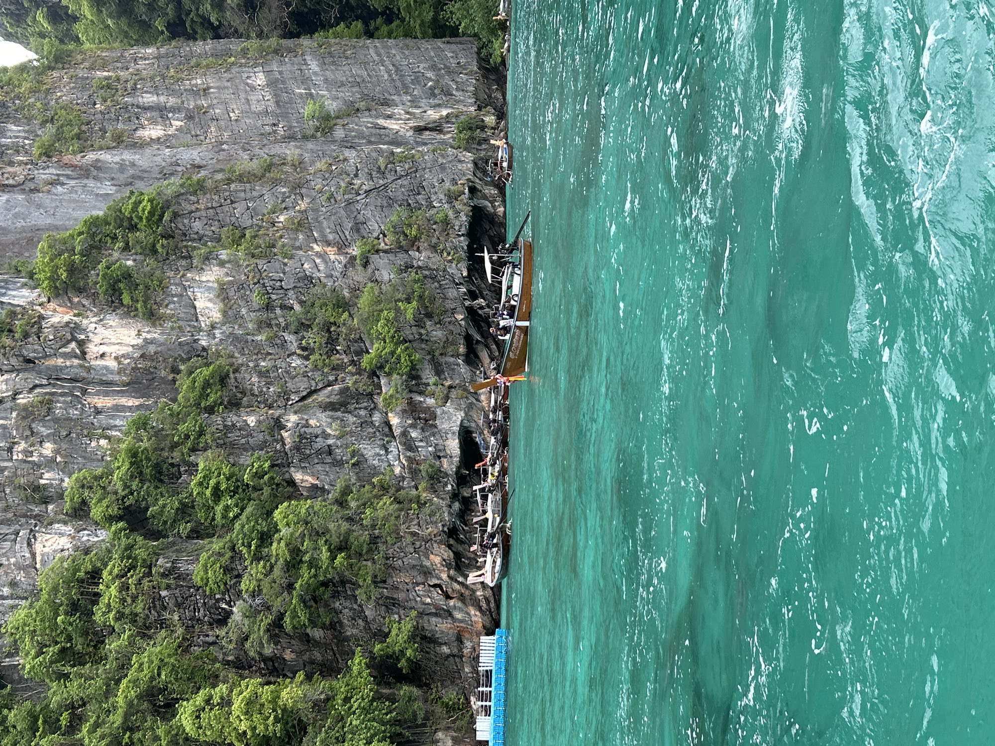 Morning boat traffic navigates limestone cliffs in Ao Nang