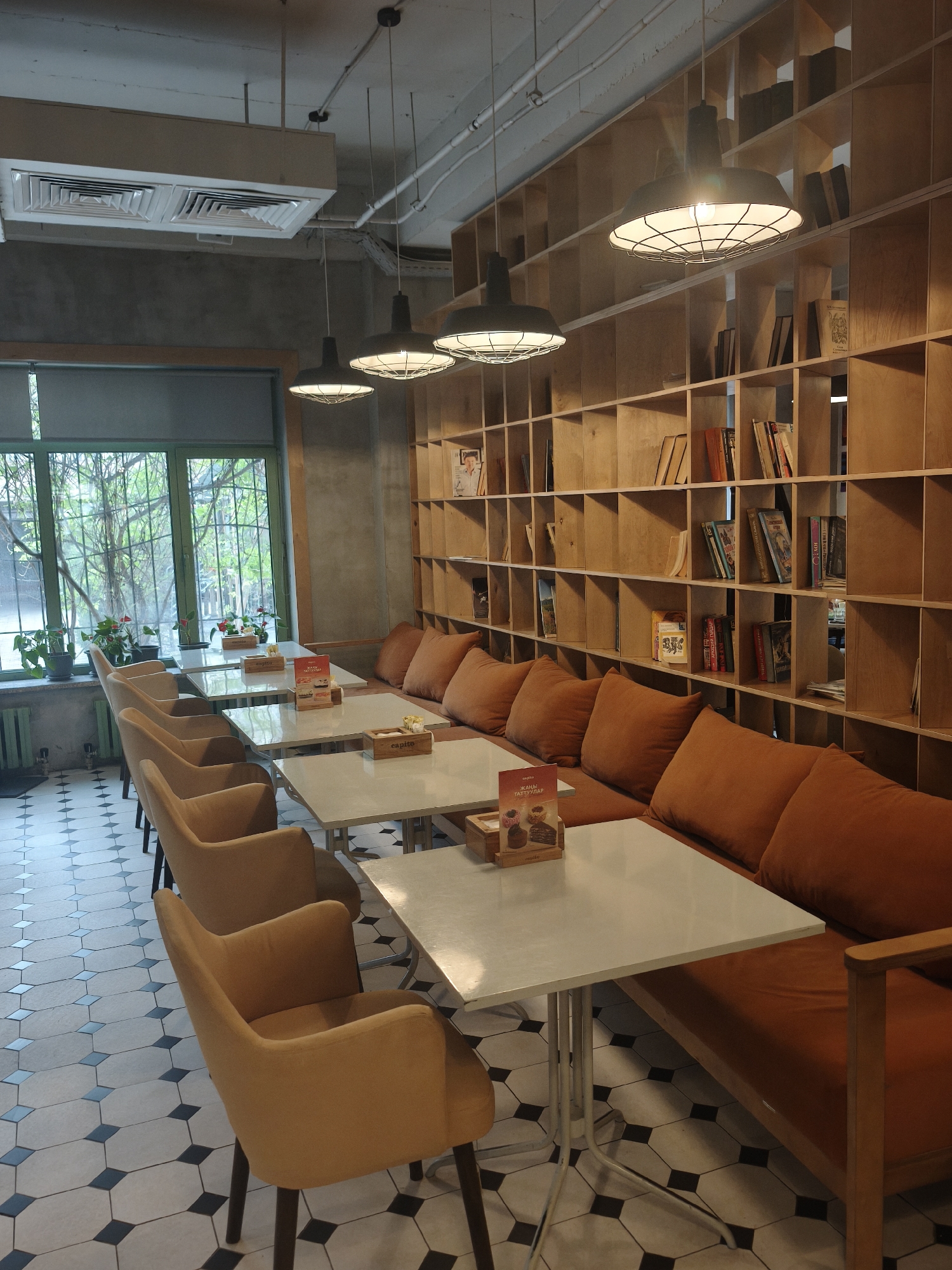 Cafe interior with pastry display captured by witness