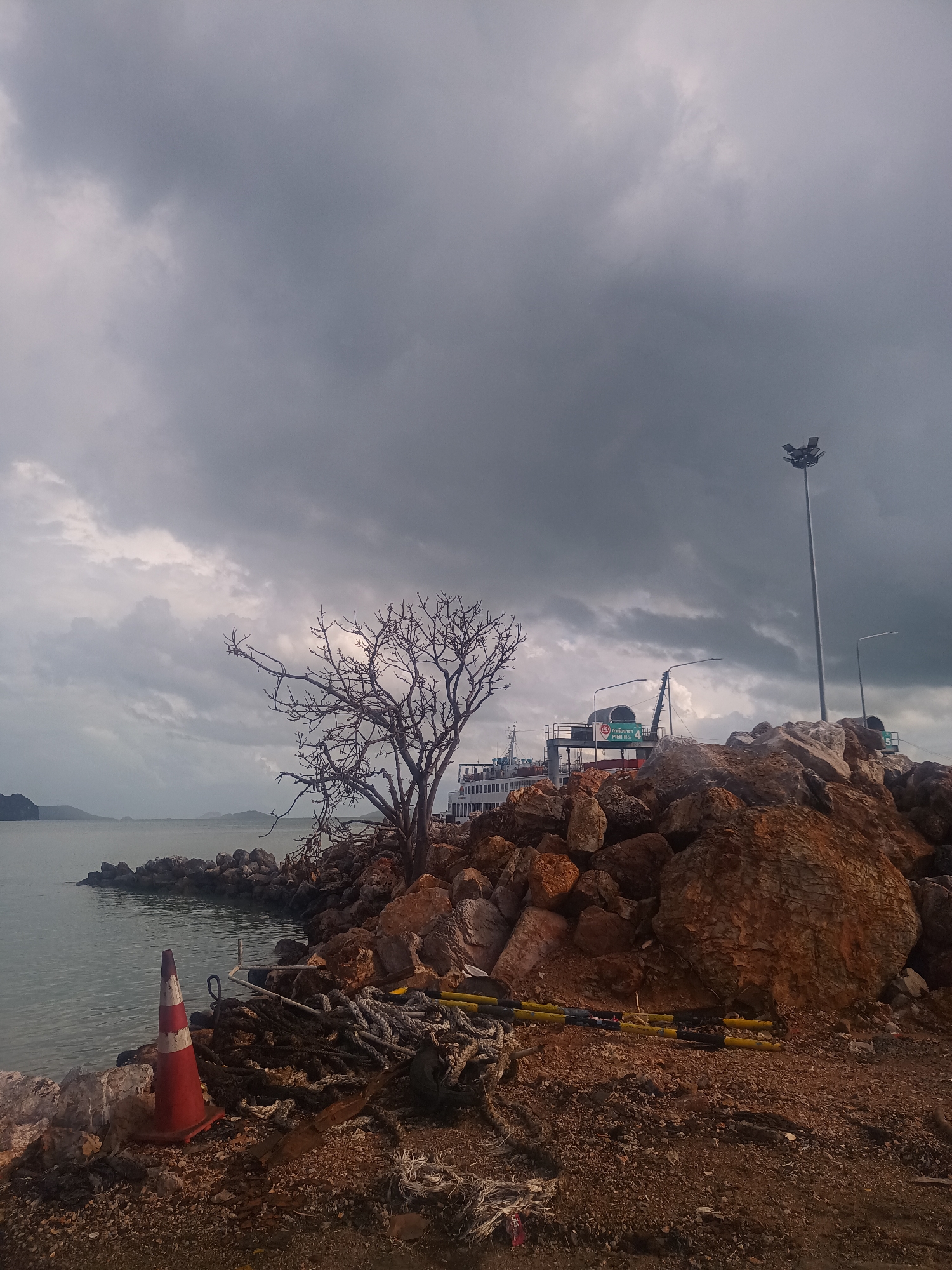 Ferry operations documented at Thai coastal harbor under overcast skies