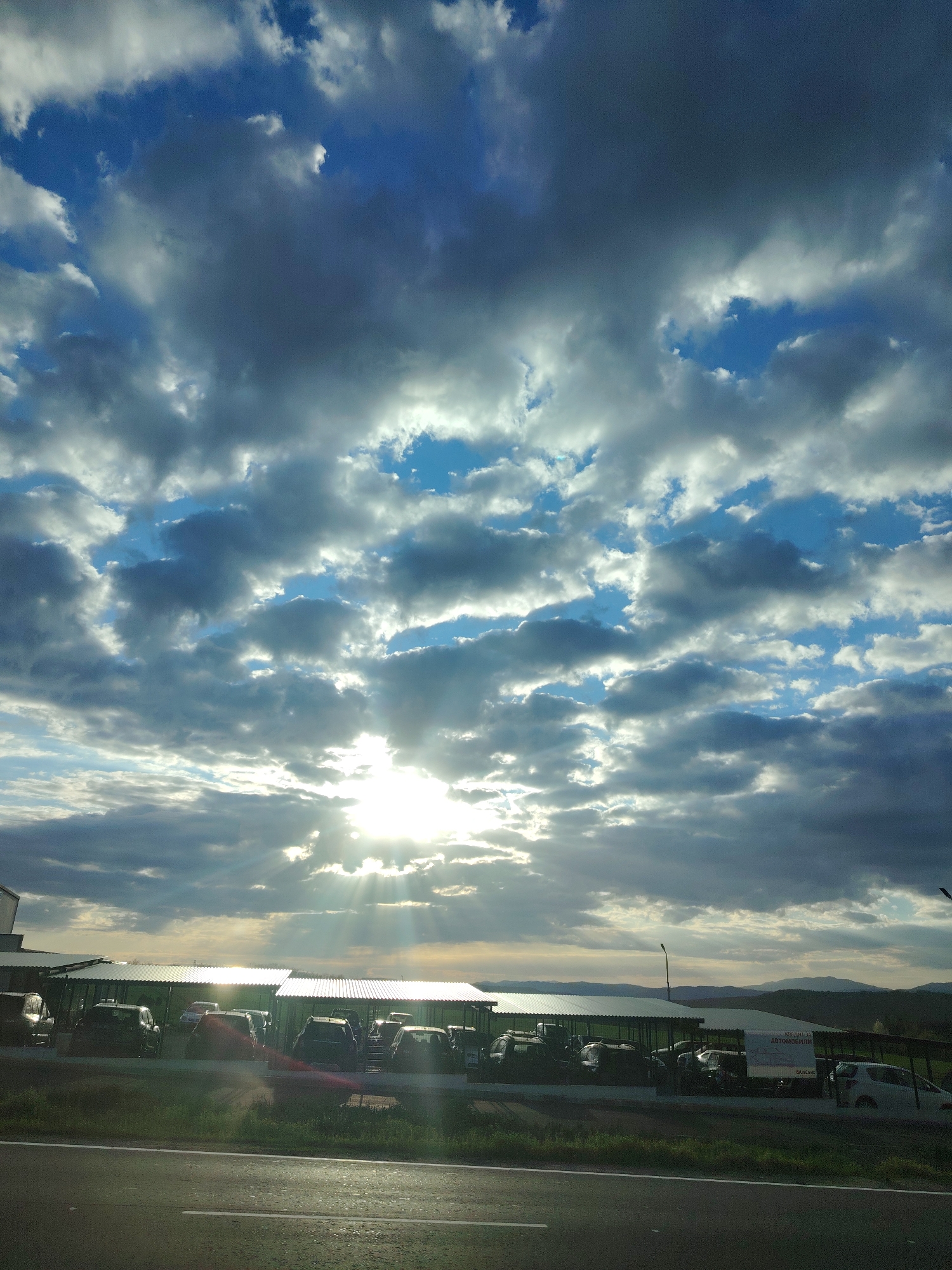 Morning sunlight through clouds over Lyaskovets parking area