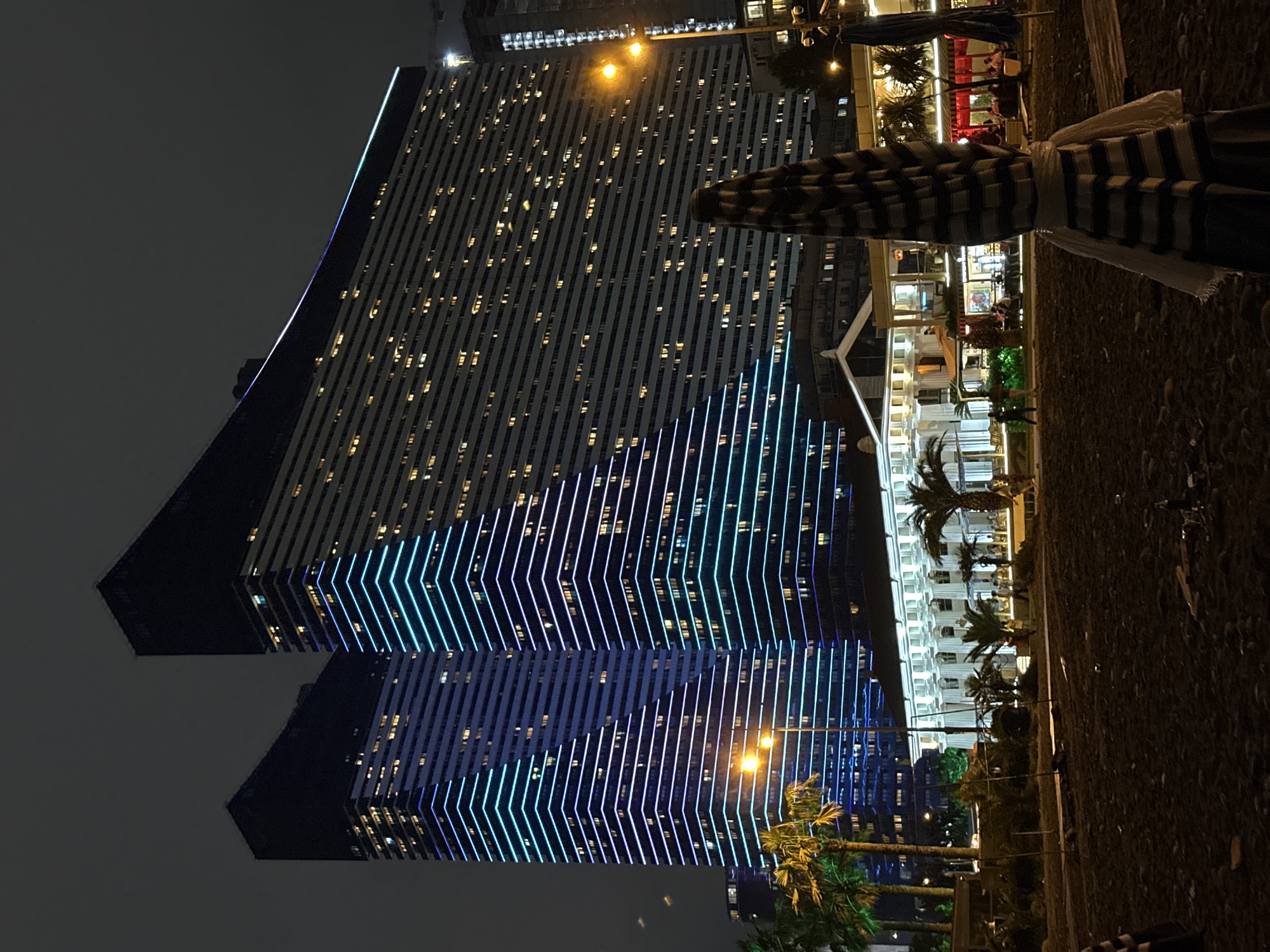 Batumi's angular towers glow blue and white after dark