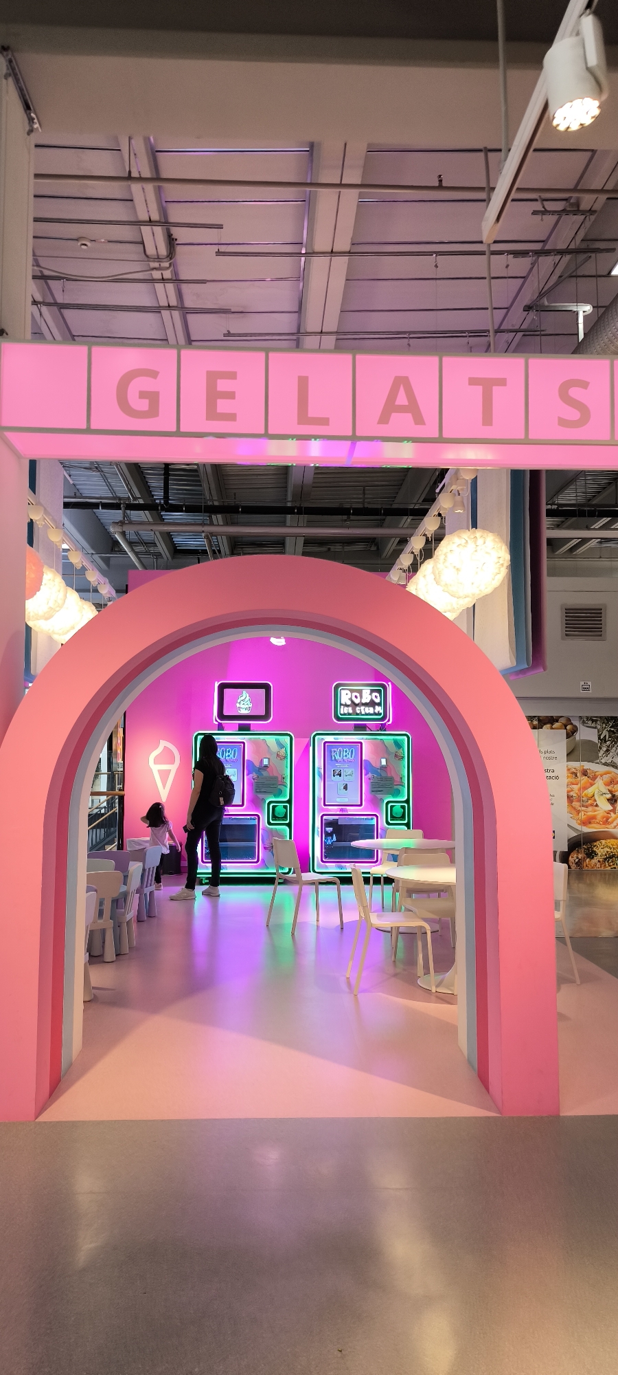 Shopper documents colorful retail store sections in Sabadell