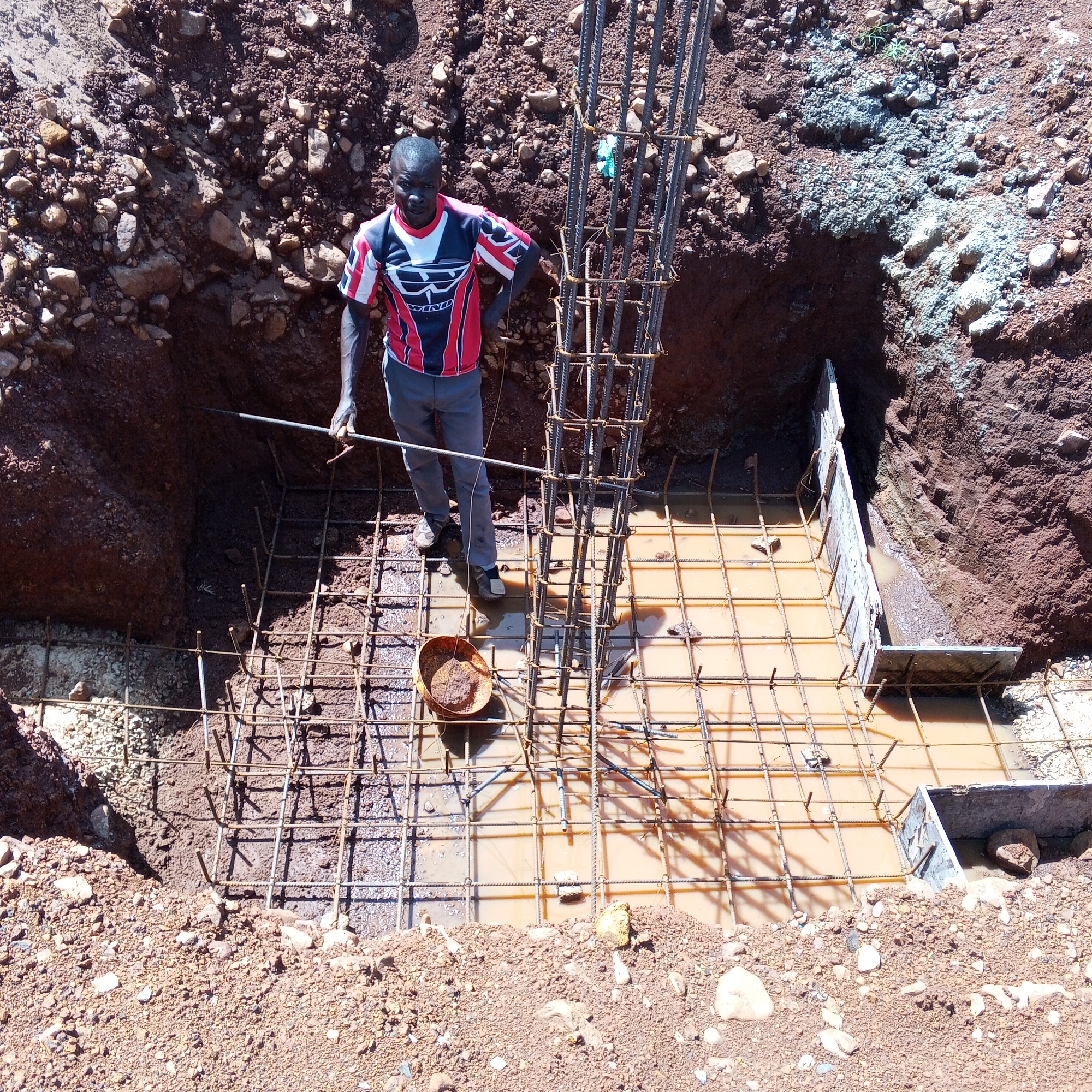 Construction workers pour foundations, install rebar in Kenya