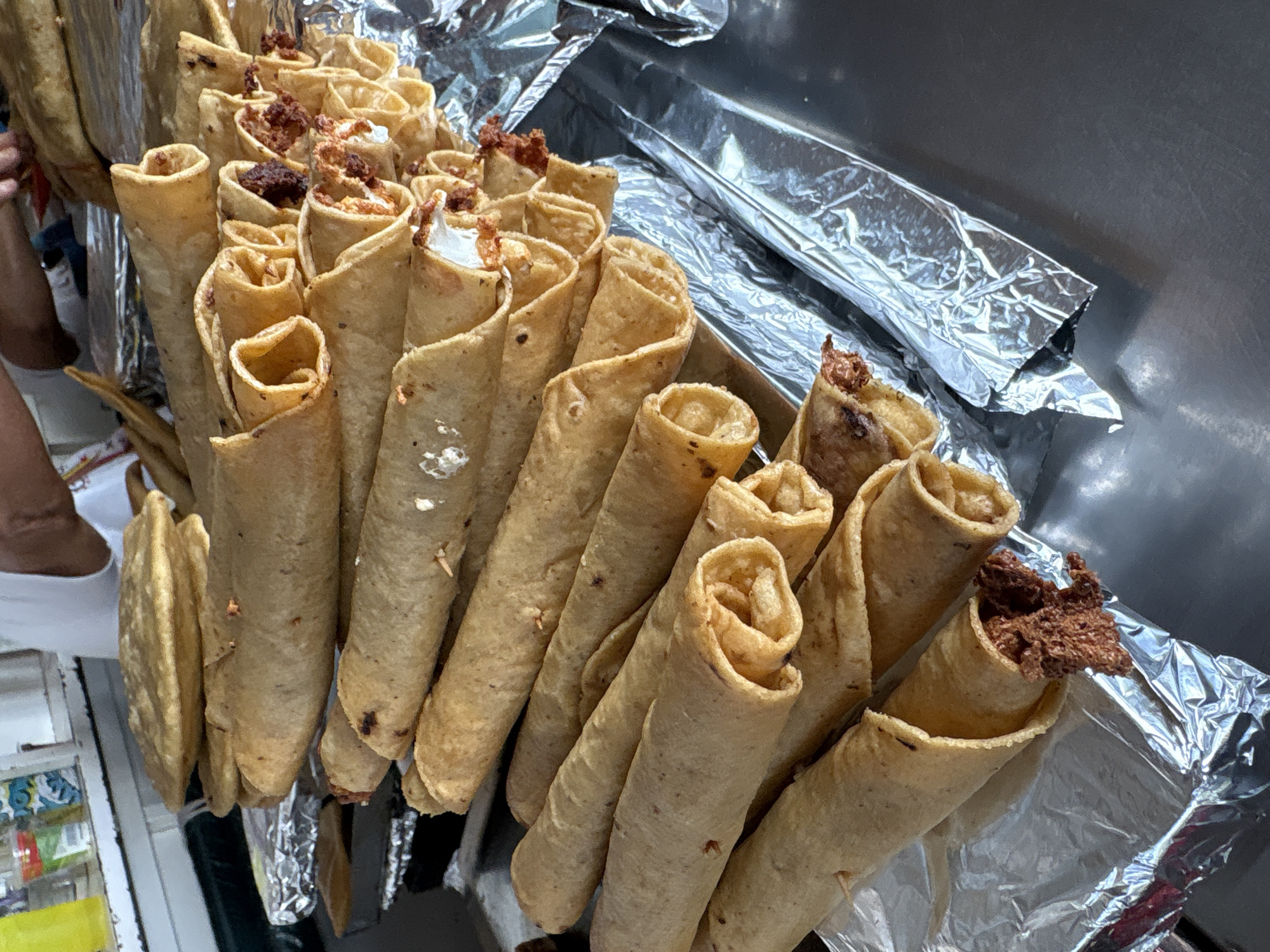 Fried tacos documented in foil container in Cuernavaca