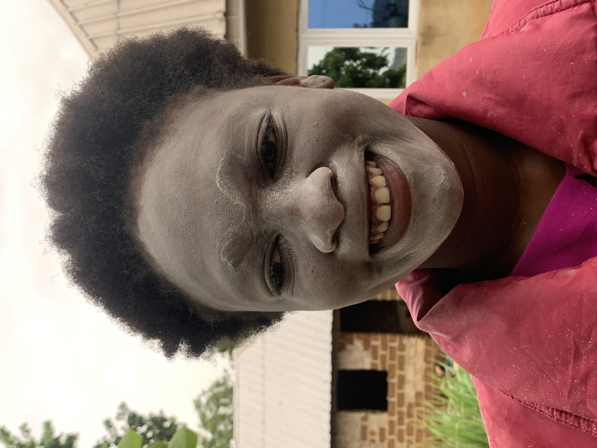 Person covered in white dust documented in rural Nigeria