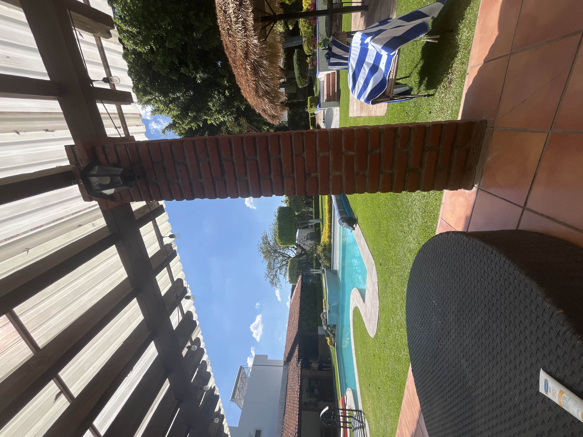 Residential backyard spaces with pool and landscaped areas documented
