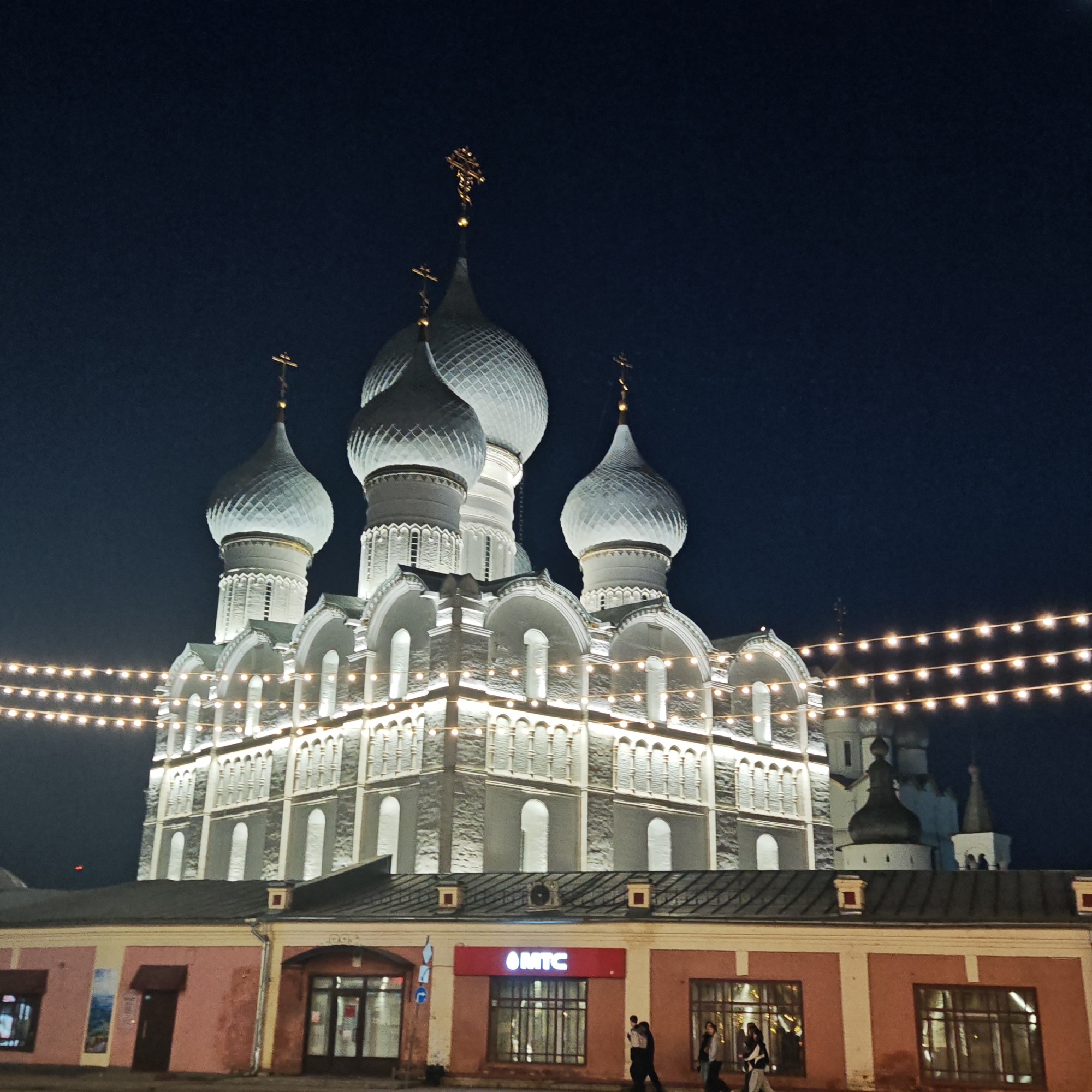 Illuminated church and decorated buildings captured in nighttime Rostov