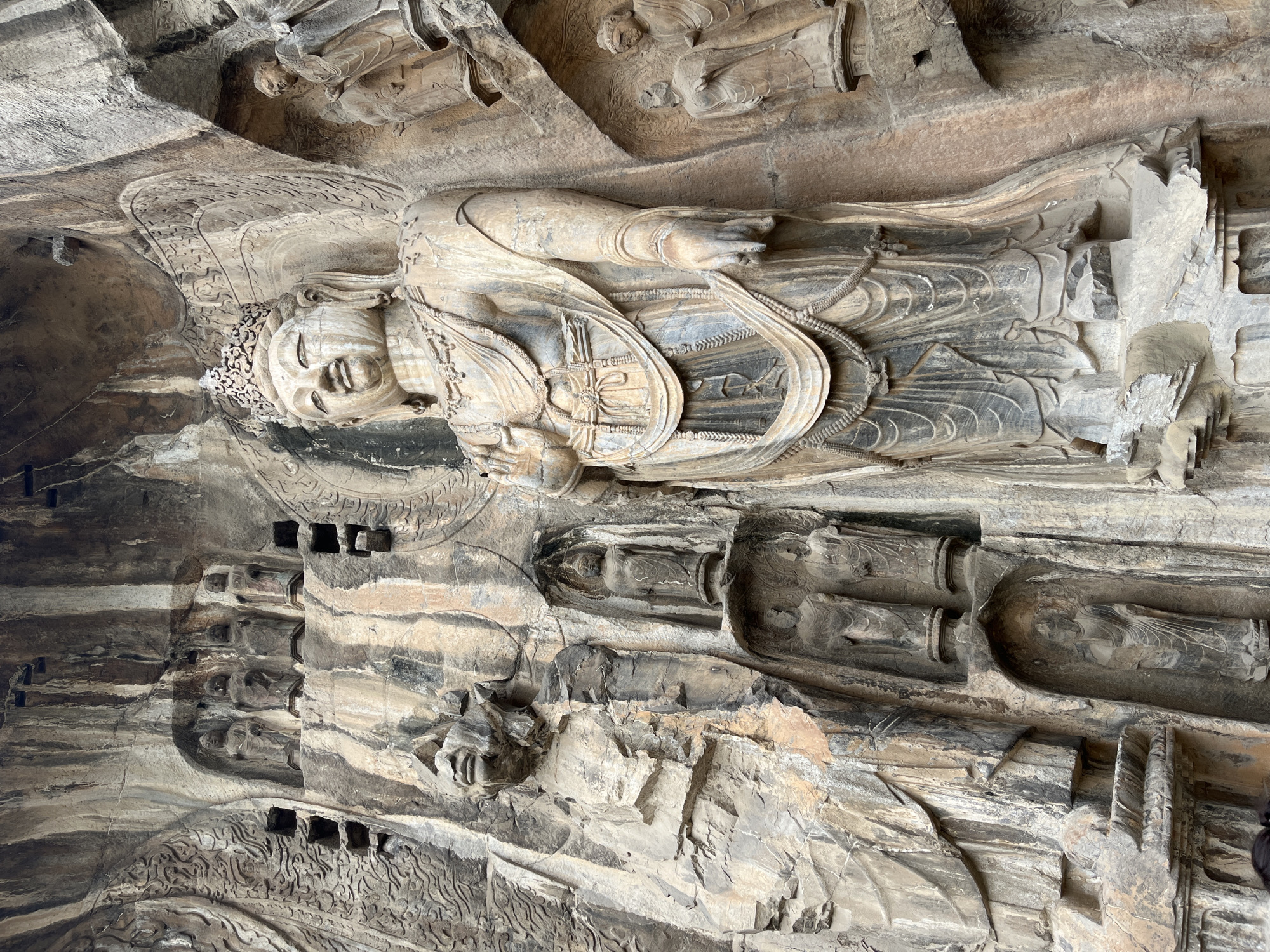 Ancient Buddhist carvings at Longmen Grottoes, plus one unbothered cat
