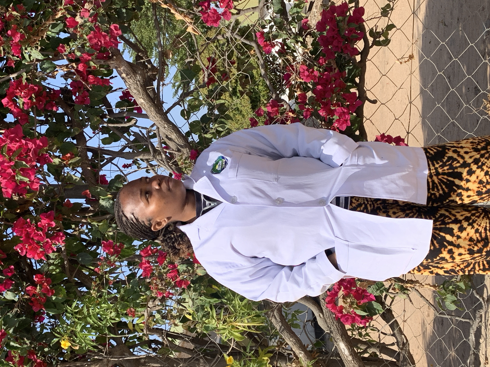 Lab coats and bougainvillea: a morning scene at Dodoma facility