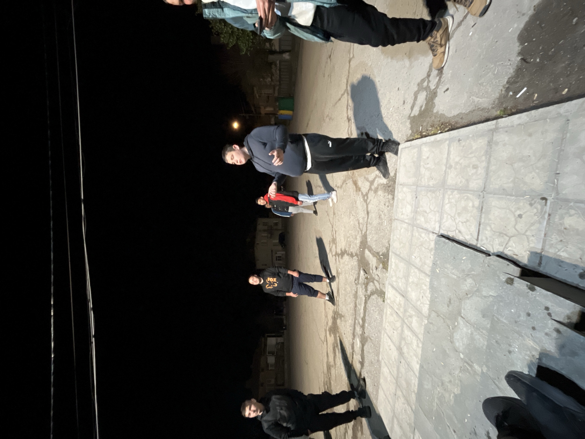 Young men play casual nighttime football in Karavelovo, Bulgaria