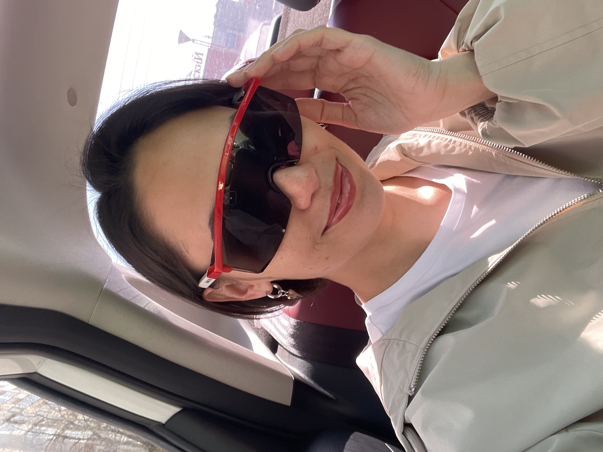 Woman takes car selfies in red sunglasses, Izhevsk