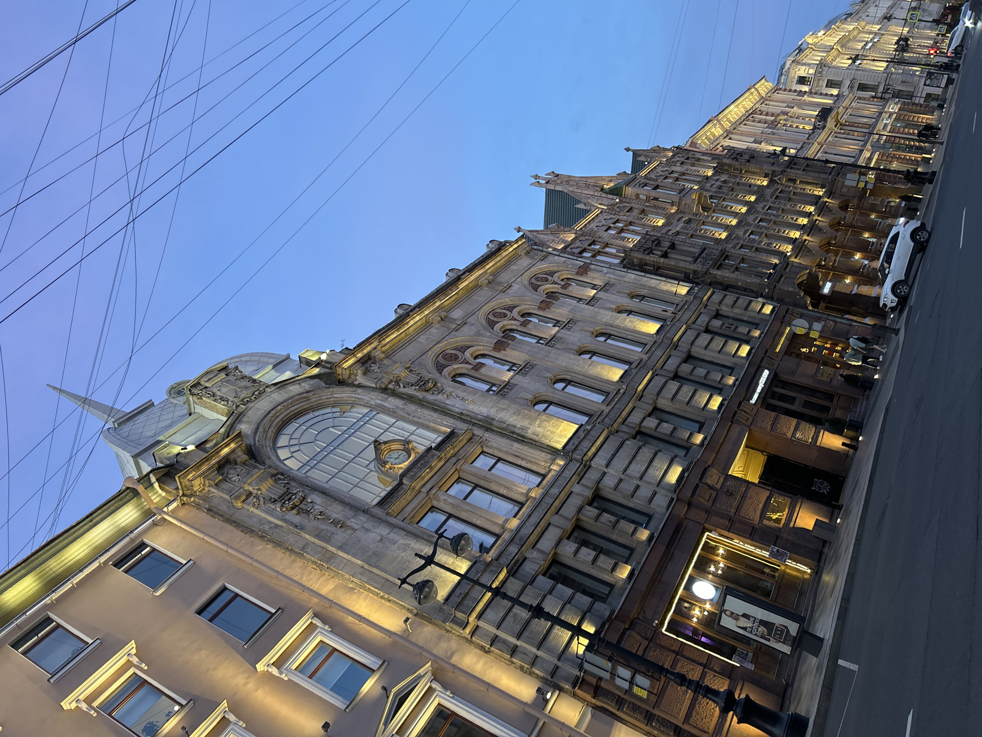 Ornate city street at dusk, blue hour setting in.