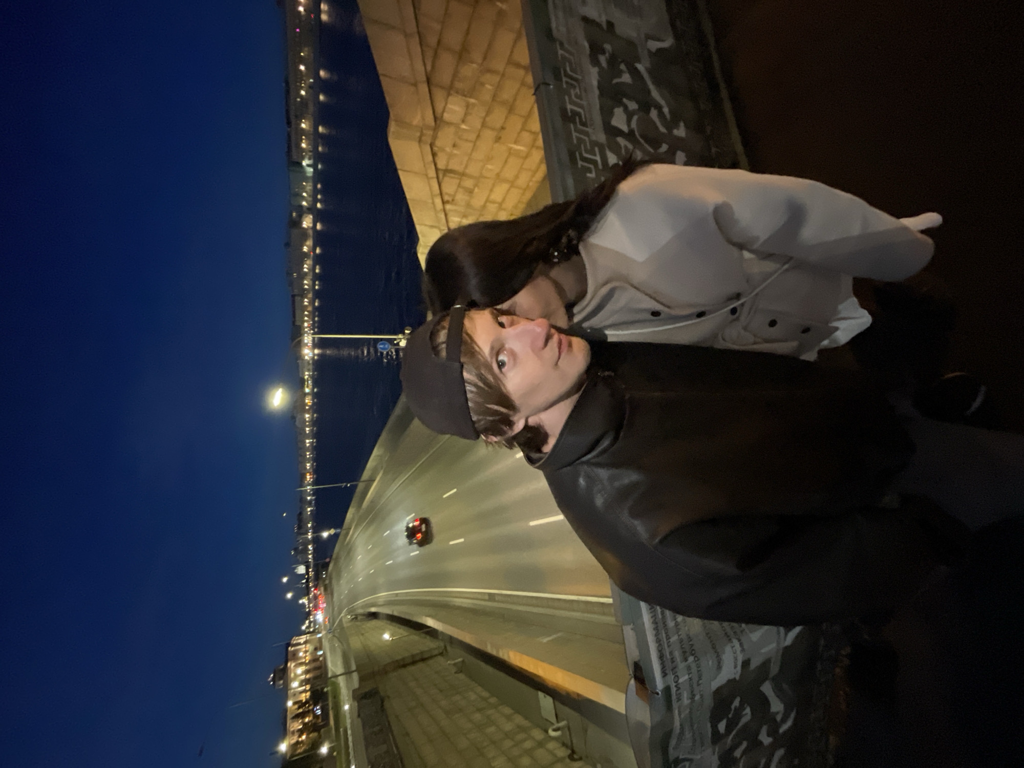 Couple photographed on bridge in Saint Petersburg at night