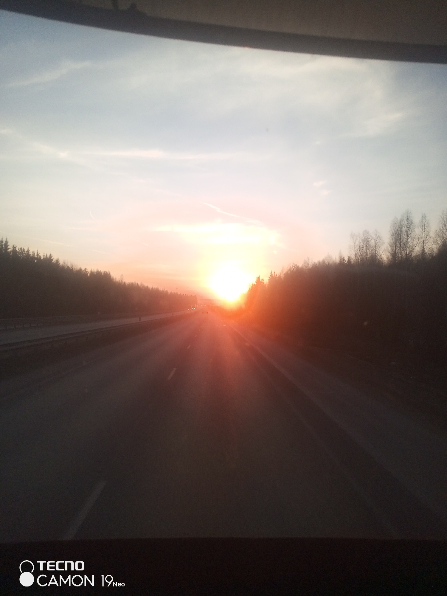 Driver captures sunset view on Russian highway near forests