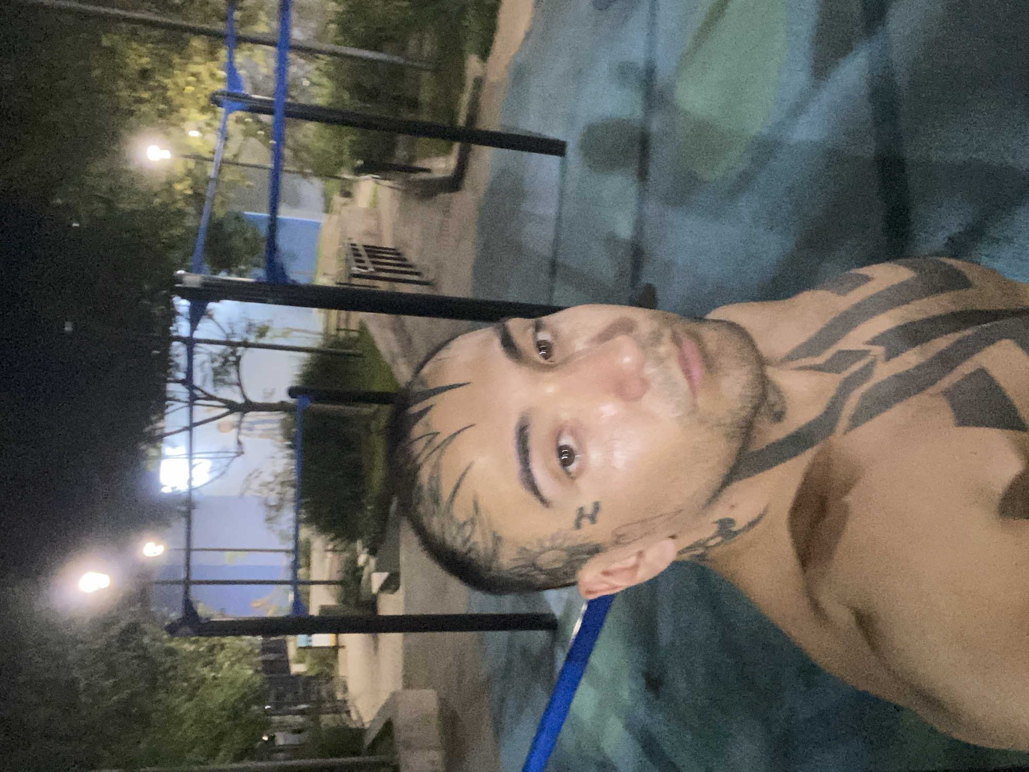 Tattooed man photographed at Buenos Aires park late night