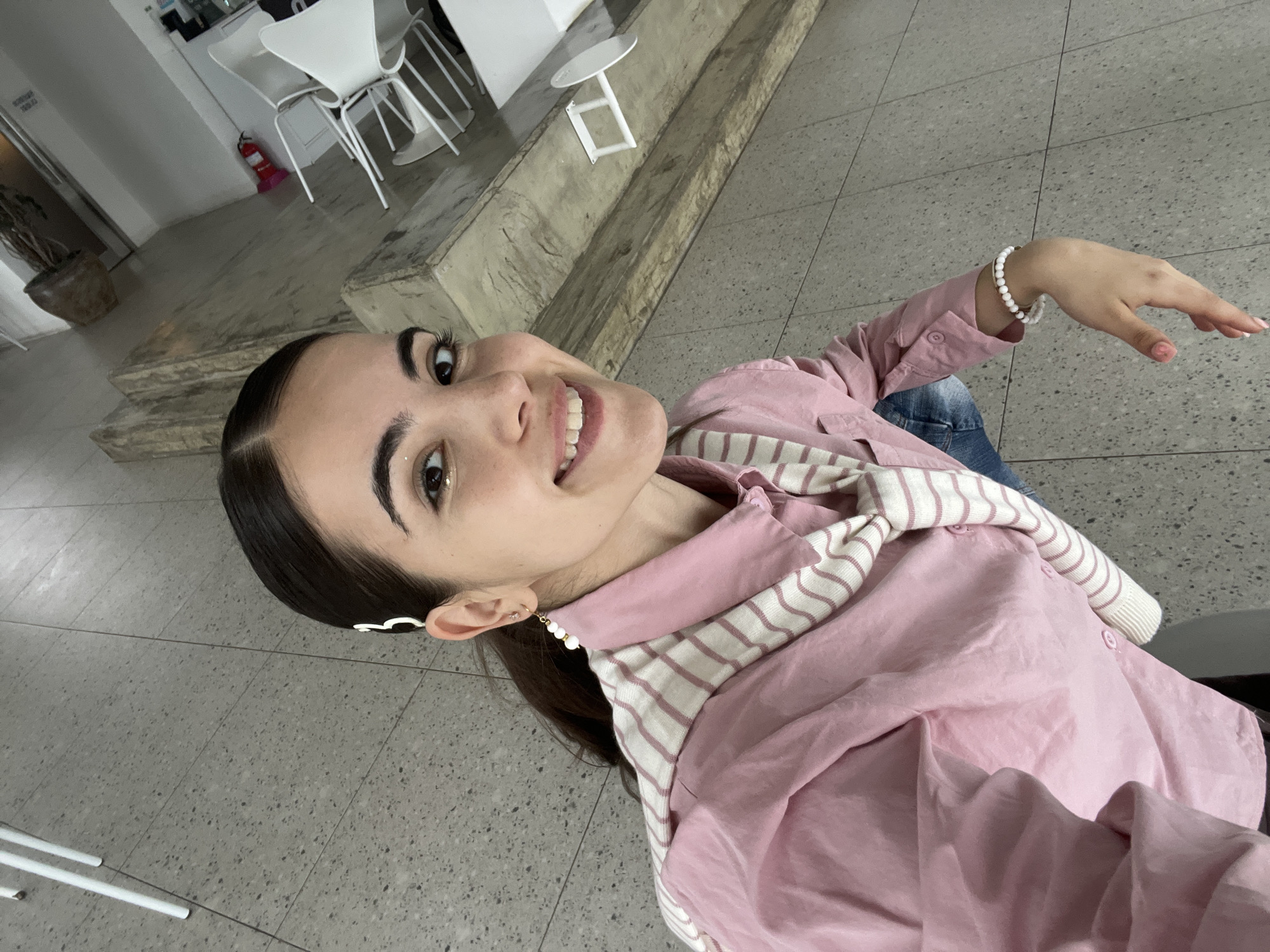 Woman in pink outfit photographed smiling in Busan