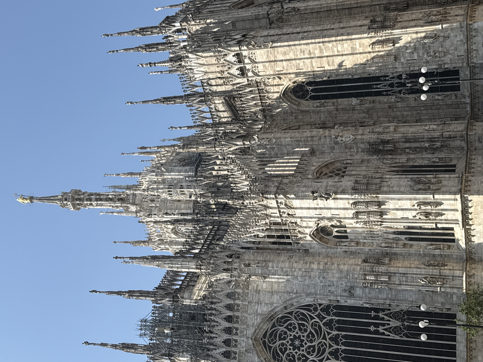 Milan Cathedral's Gothic architecture photographed under clear skies