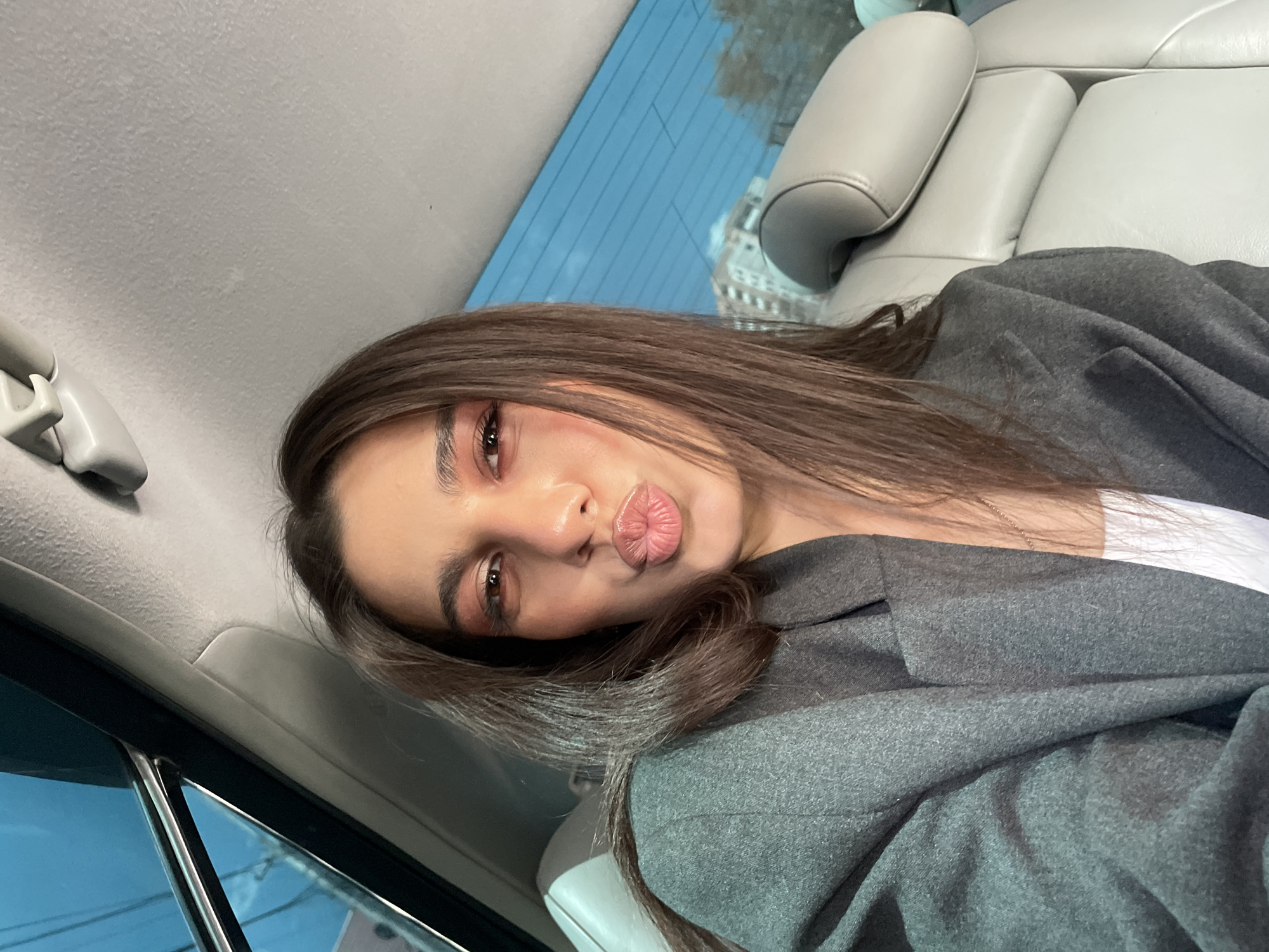 Woman takes selfie in car backseat in Yerevan