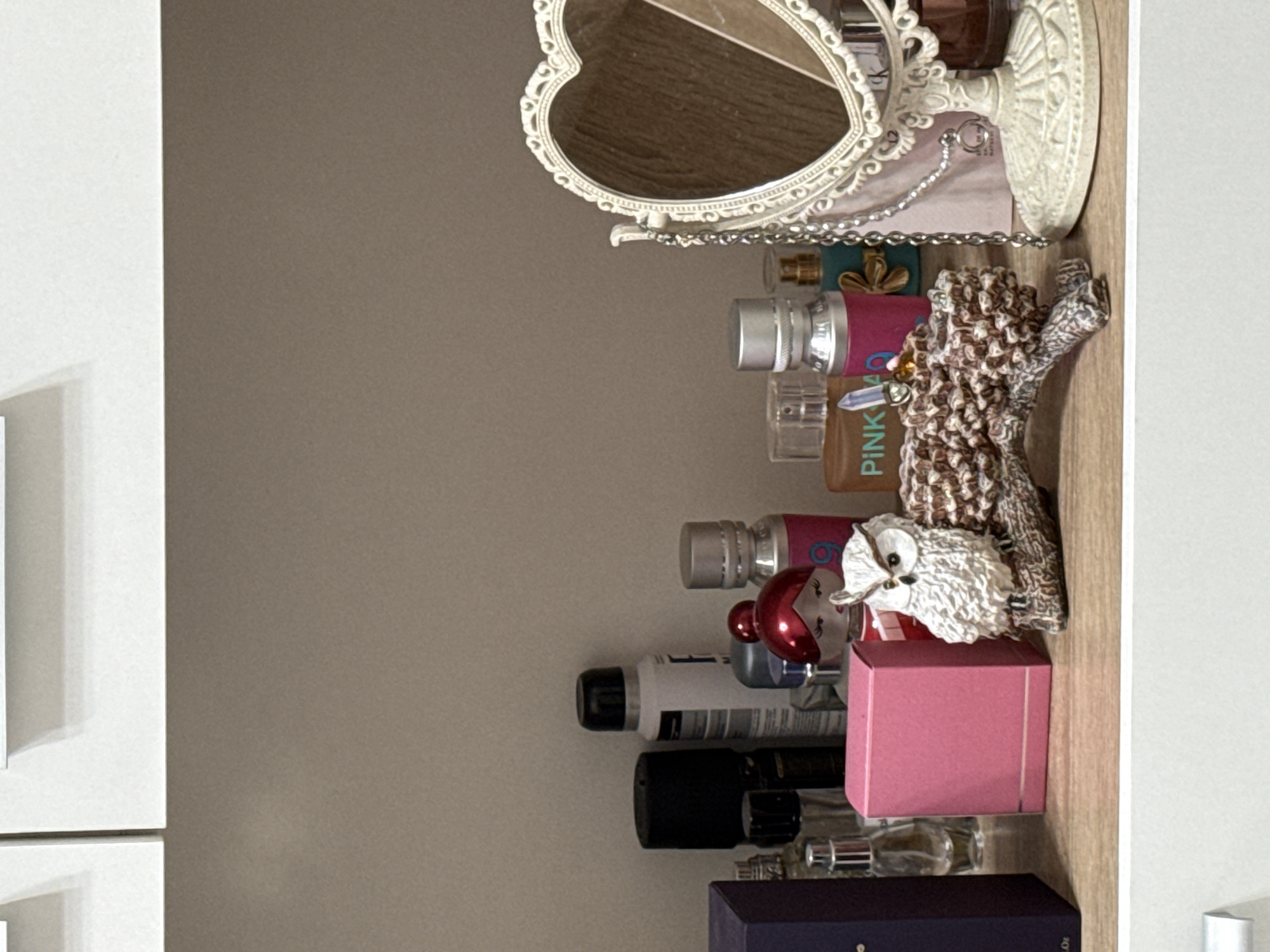 Interior home spaces documented showing decorative shelf and electrical outlet