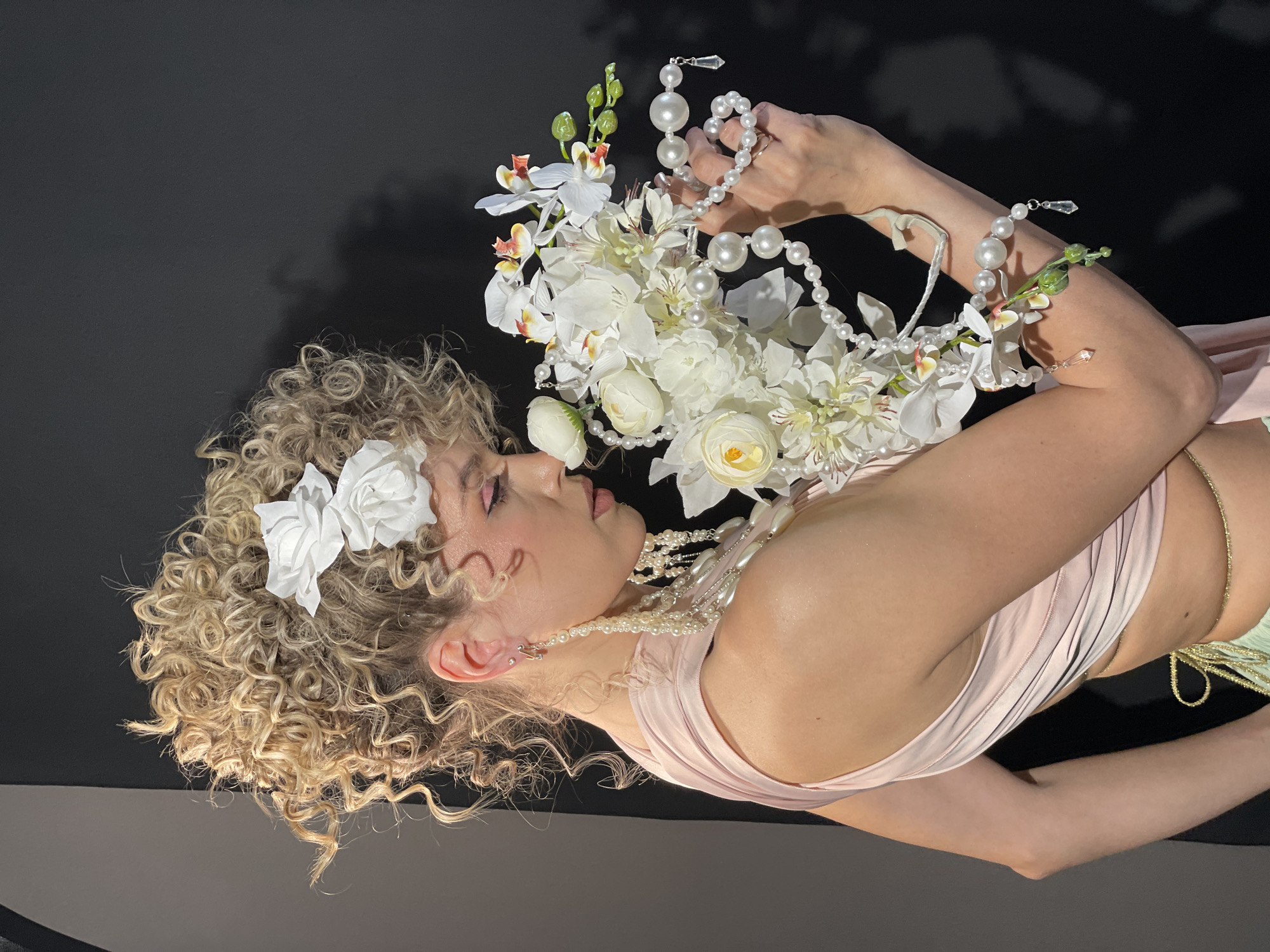 Woman poses for formal portrait with flowers in Russia