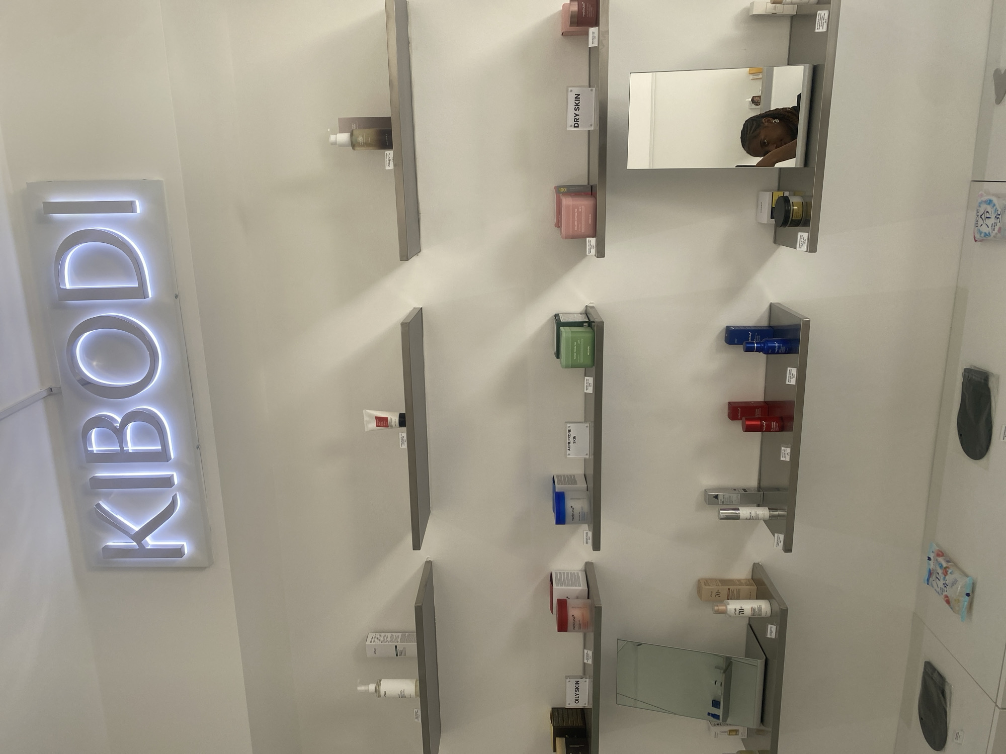 Customer browses cosmetics at London beauty store, displays colorful nail art