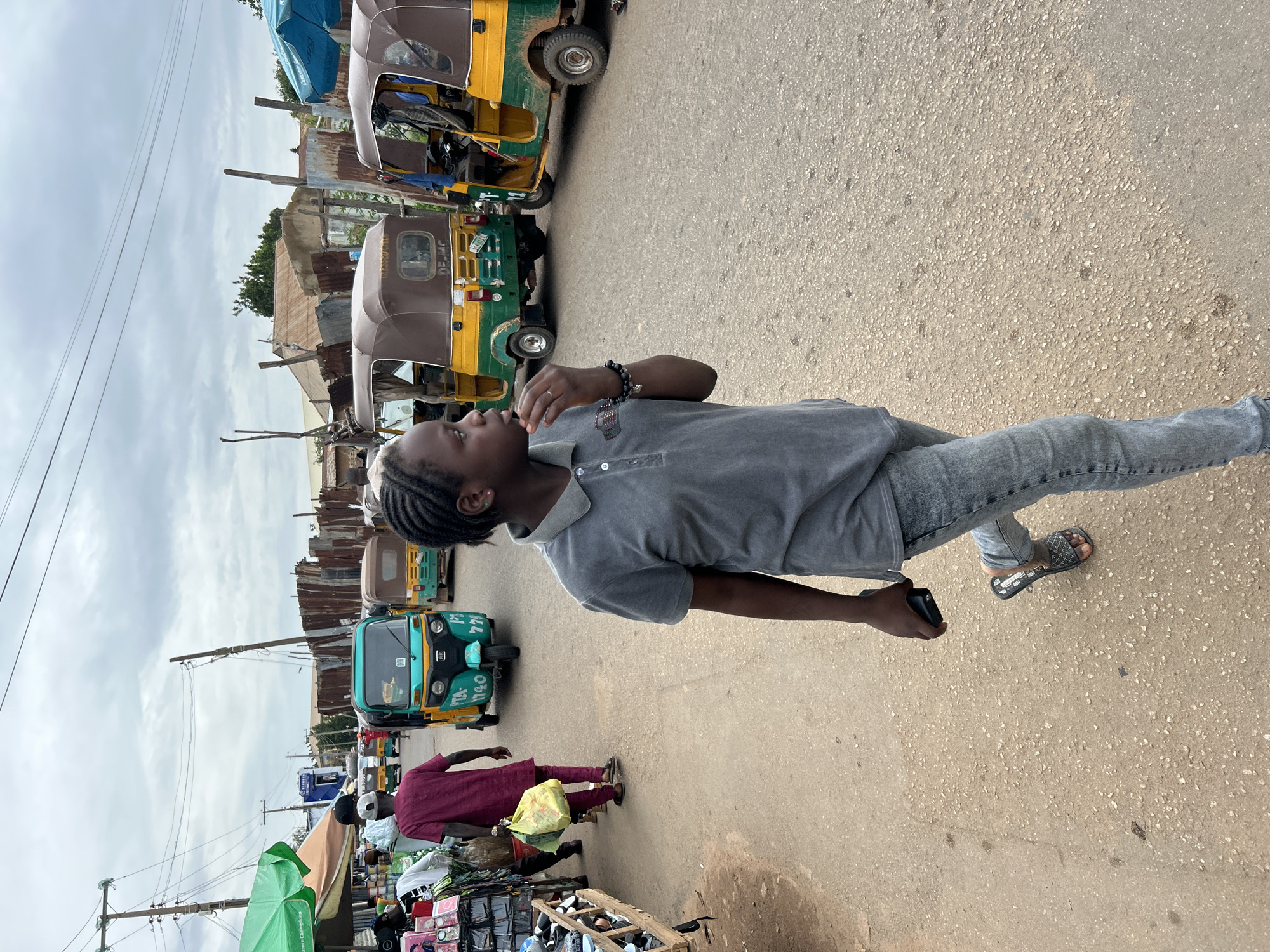 Street vendors and shoppers fill a busy outdoor market